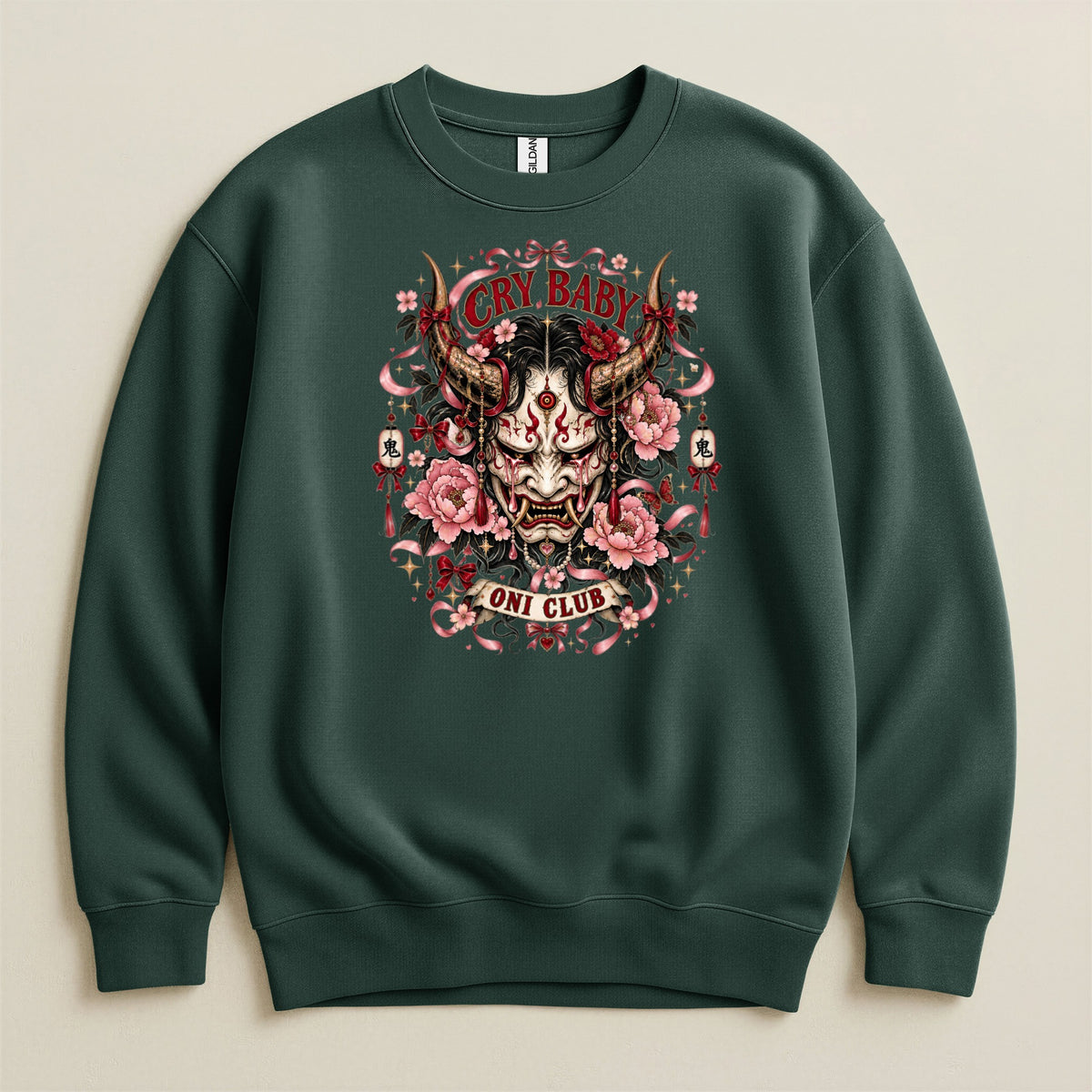 Dark green sweatshirt with a central graphic of a crying Oni mask, pink peonies, and the text "CRY BABY" and "ONI CLUB".