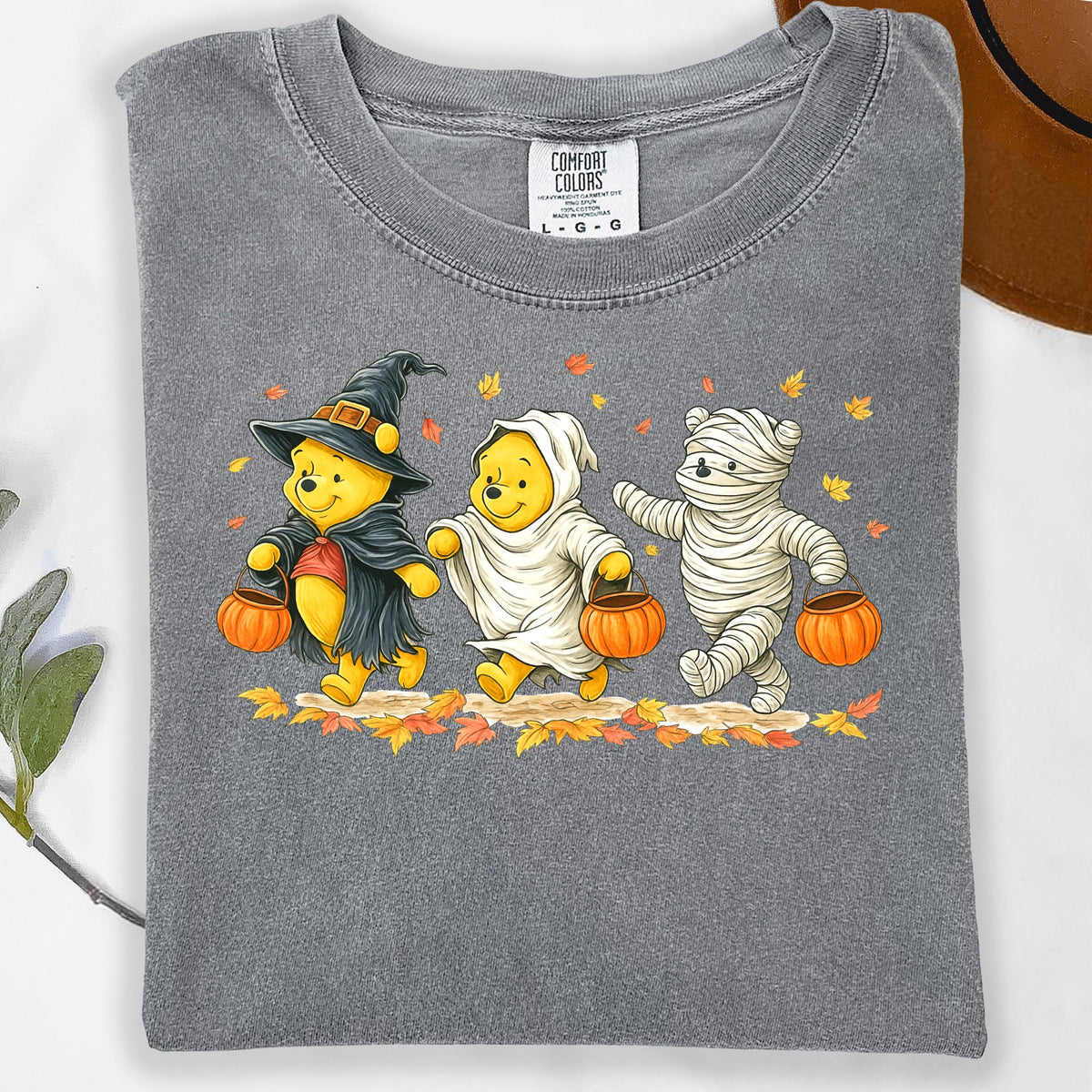 Winnie the Pooh characters in Halloween costumes with pumpkins and autumn leaves.
