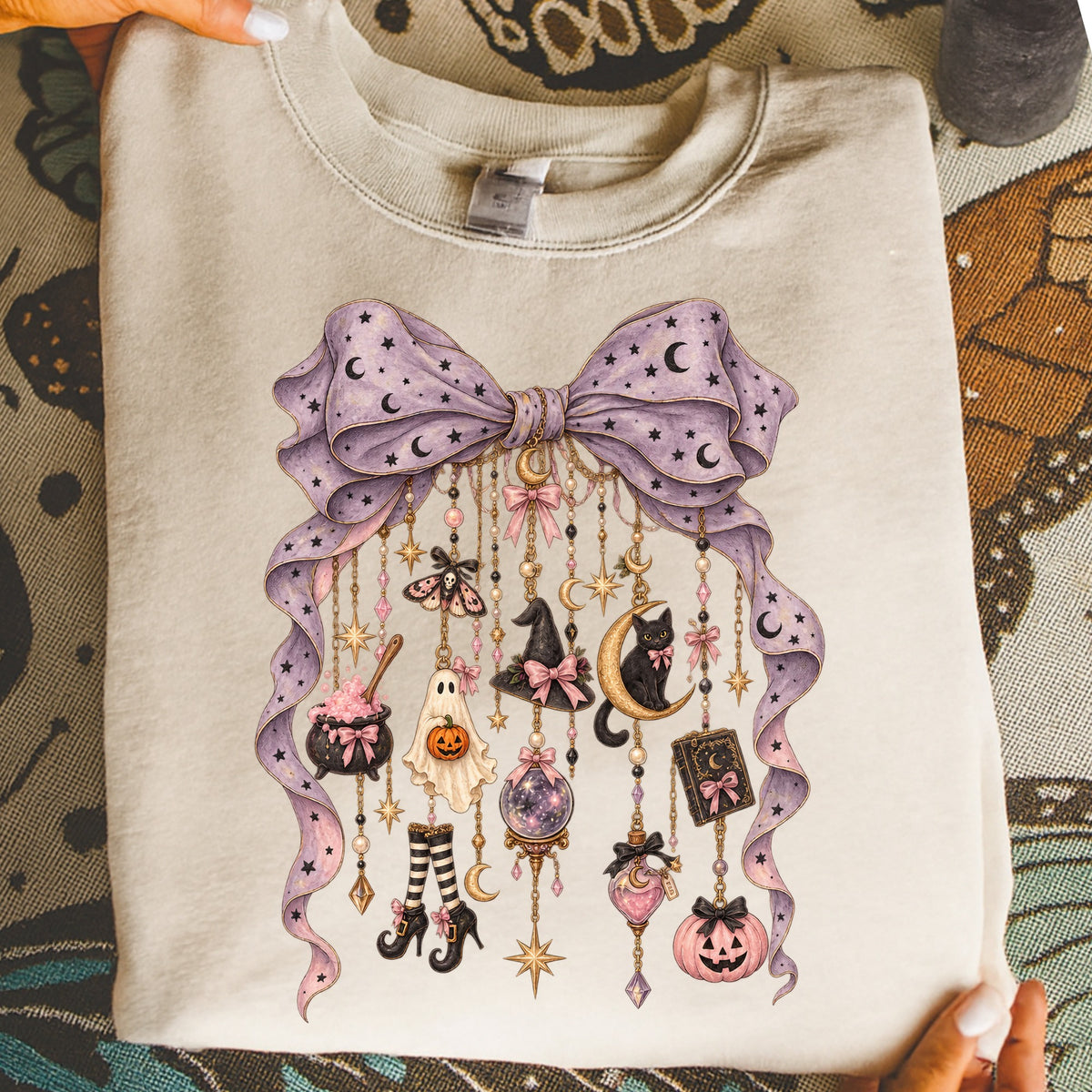 Lightweight sweatshirt with a purple bow and hanging Halloween-themed charms.