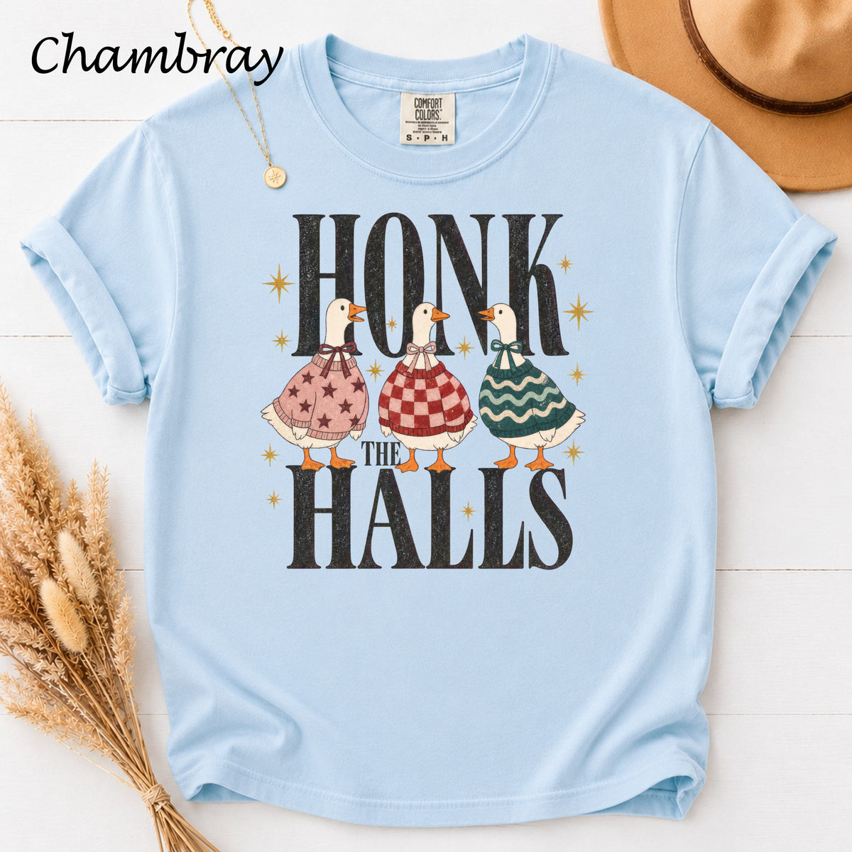 Light blue t-shirt with "Honk The Halls" graphic featuring three geese in festive sweaters.