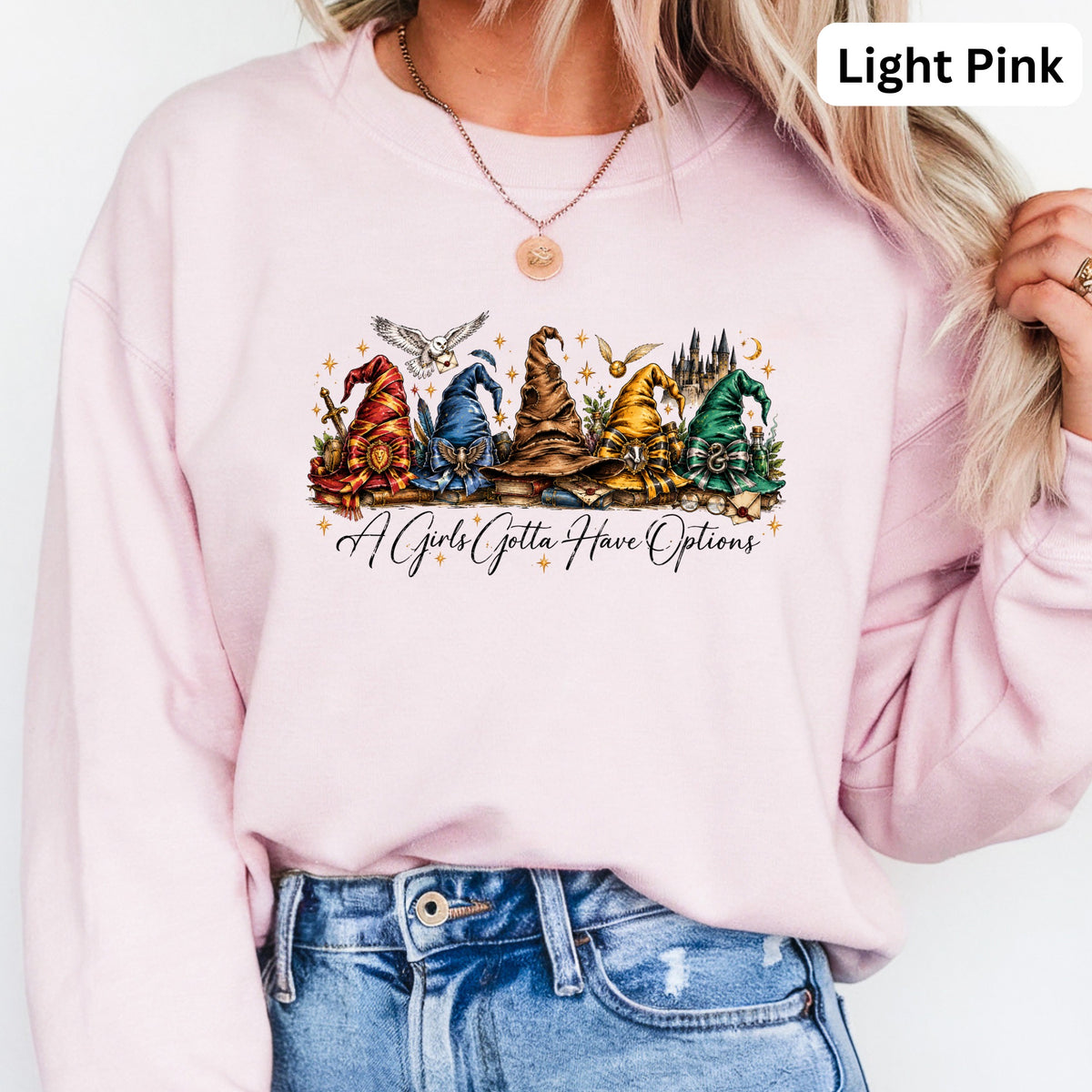 Light pink sweatshirt with wizard hats and the text "A Girls Gotta Have Options".