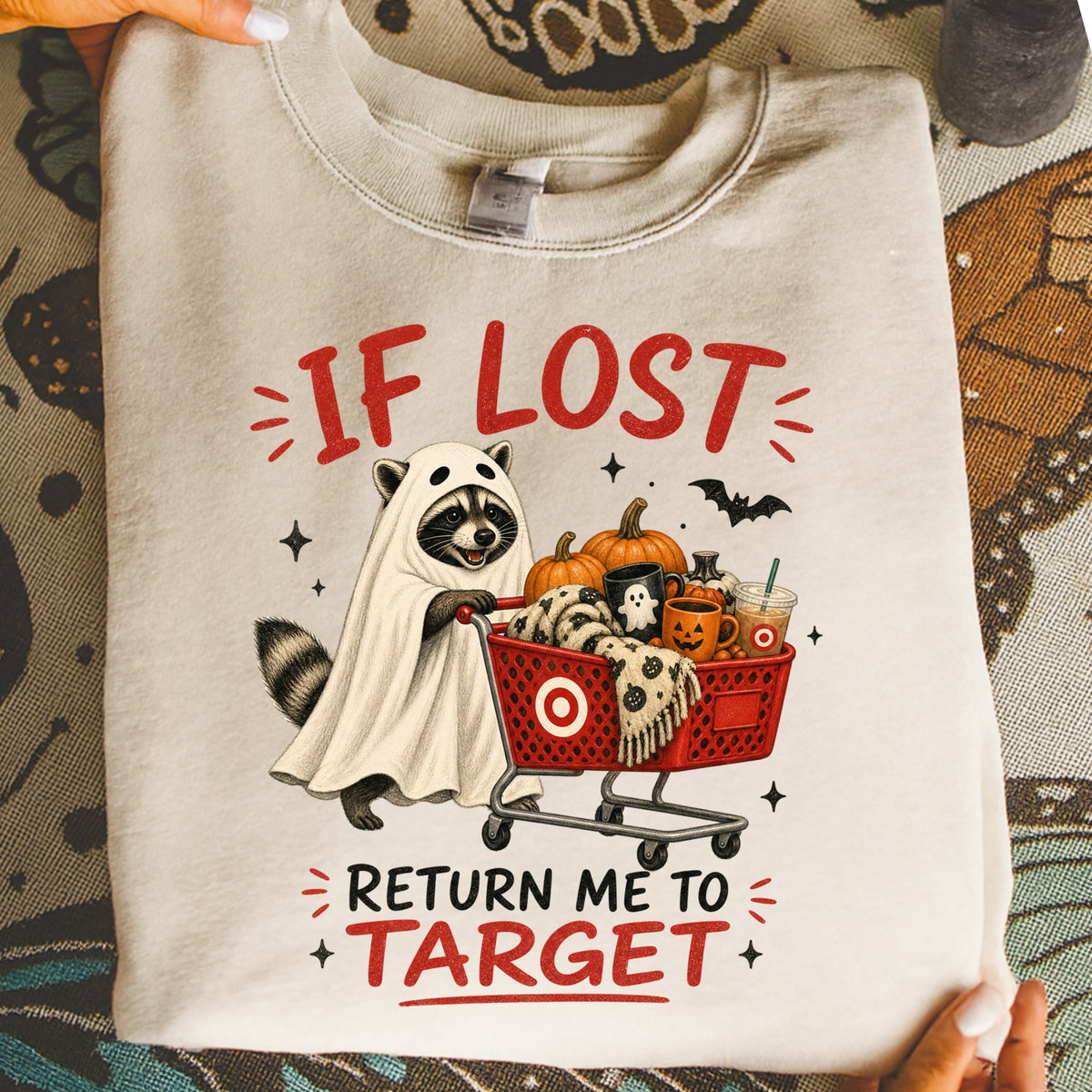 Raccoon in ghost costume pushing Target shopping cart with pumpkins and mugs, reads "If Lost Return Me To Target".