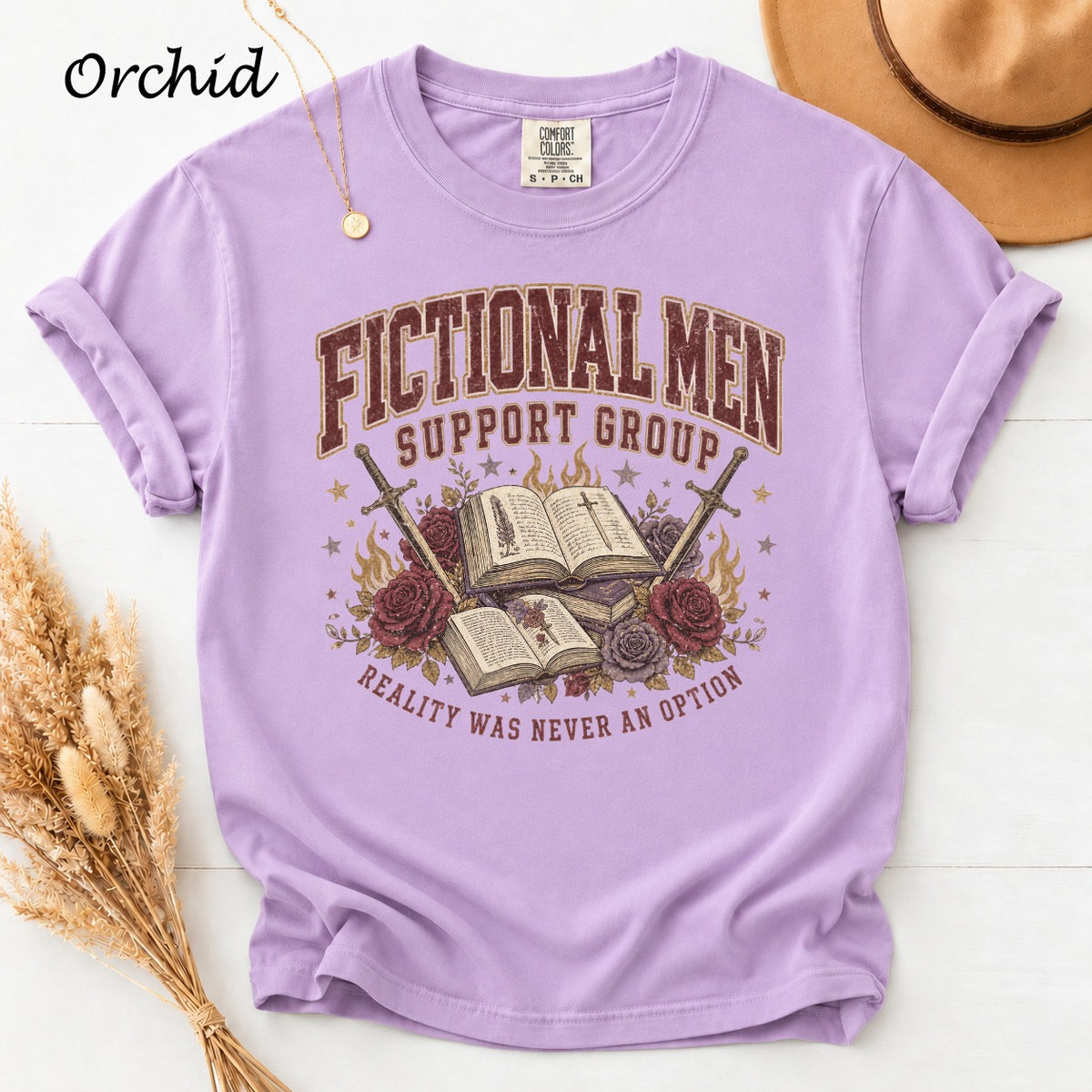Purple t-shirt with "Fictional Men Support Group" text, books, swords, and roses.