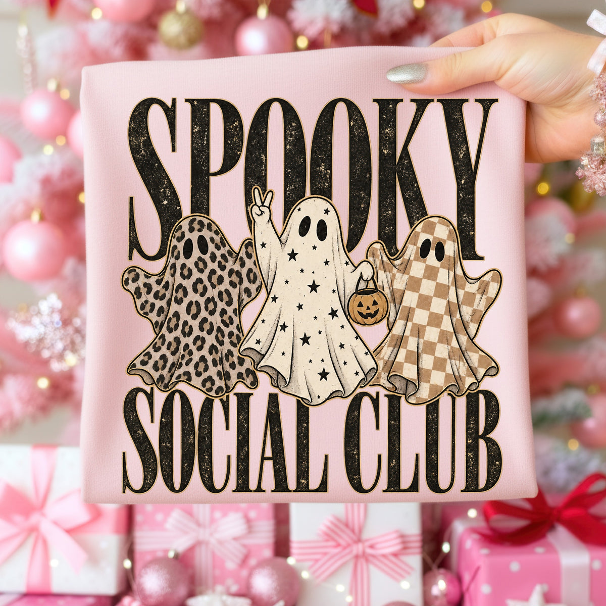 "Spooky Social Club" text with three ghost illustrations on a pink shirt.