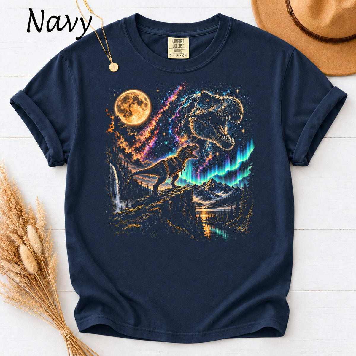 Navy t-shirt with dinosaurs, moon, aurora borealis, waterfall, and mountains graphic.
