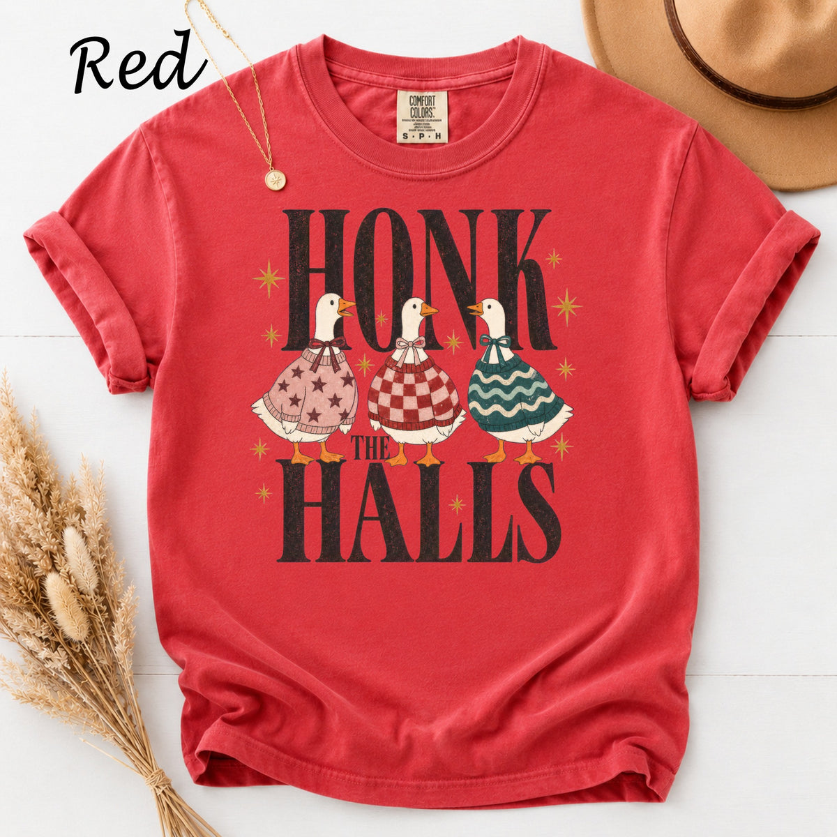 Red t-shirt with three geese wearing sweaters and the text "HONK THE HALLS".