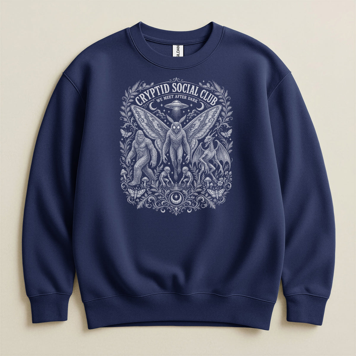 Navy sweatshirt with "Cryptid Social Club We Meet After Dark" graphic featuring cryptids.