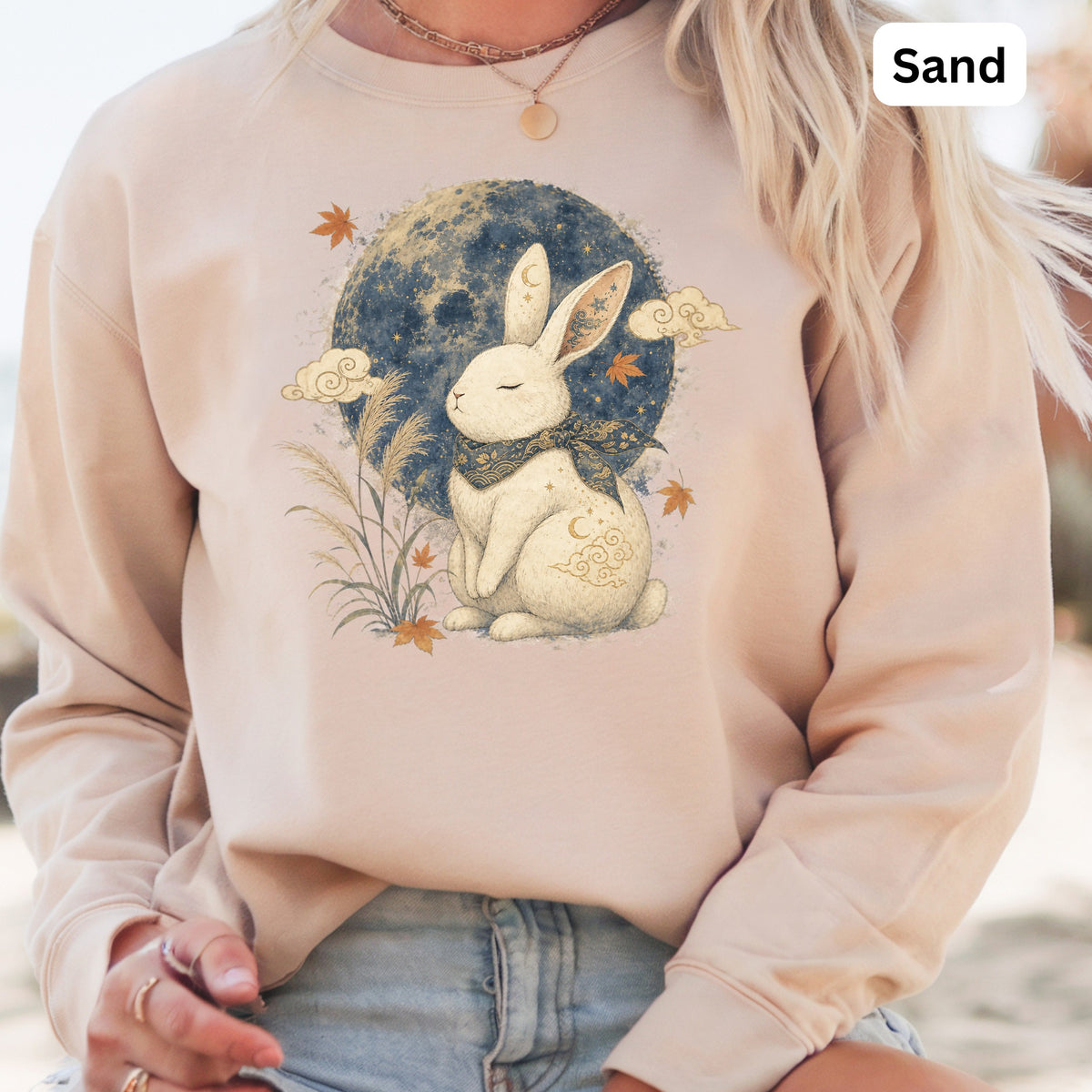 Sand colored sweatshirt with a white rabbit illustration and moon.