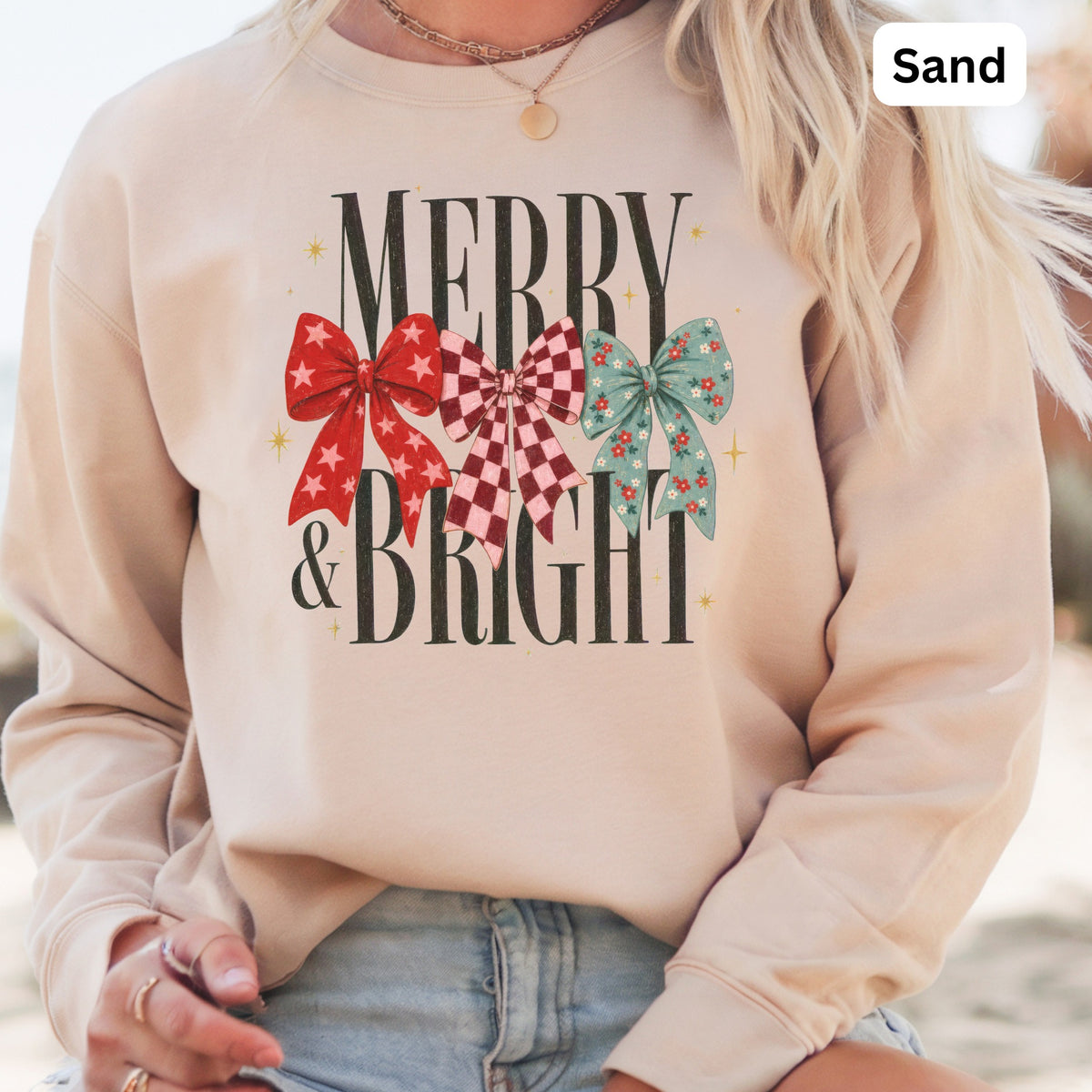Light tan sweatshirt with "Merry & Bright" text and three festive bows.