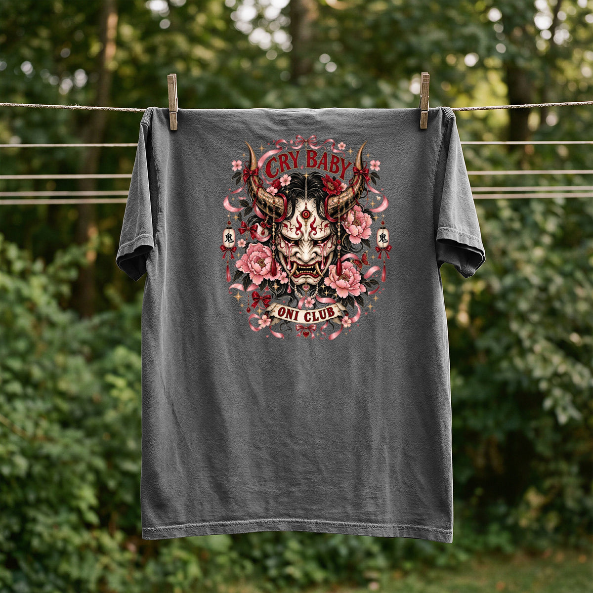 Dark grey t-shirt featuring a crying oni mask, peonies, and text "CRY BABY ONI CLUB".
