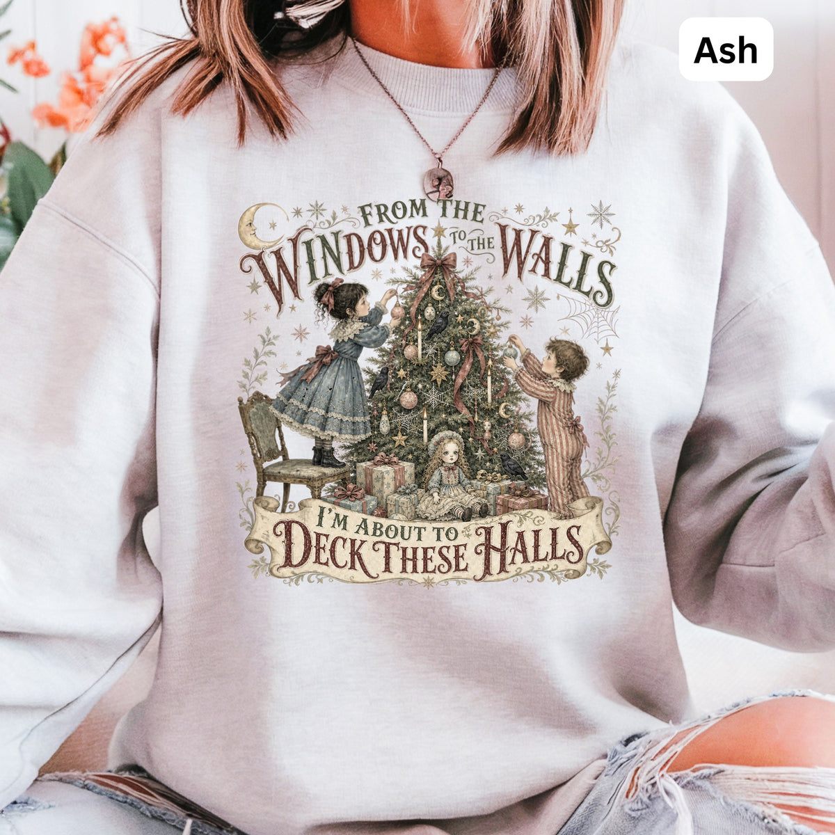 Crewneck sweatshirt with vintage illustration of children decorating a Christmas tree and text "From the Windows to the Walls. I'm About to Deck These Halls."