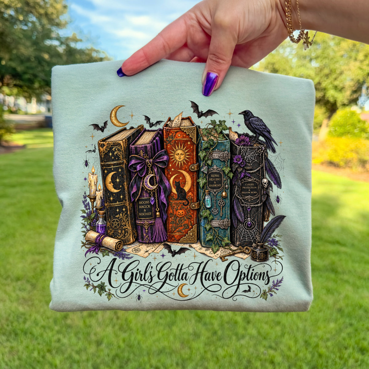 Gothic books with moons, bats, and ravens; "A Girl's Gotta Have Options".