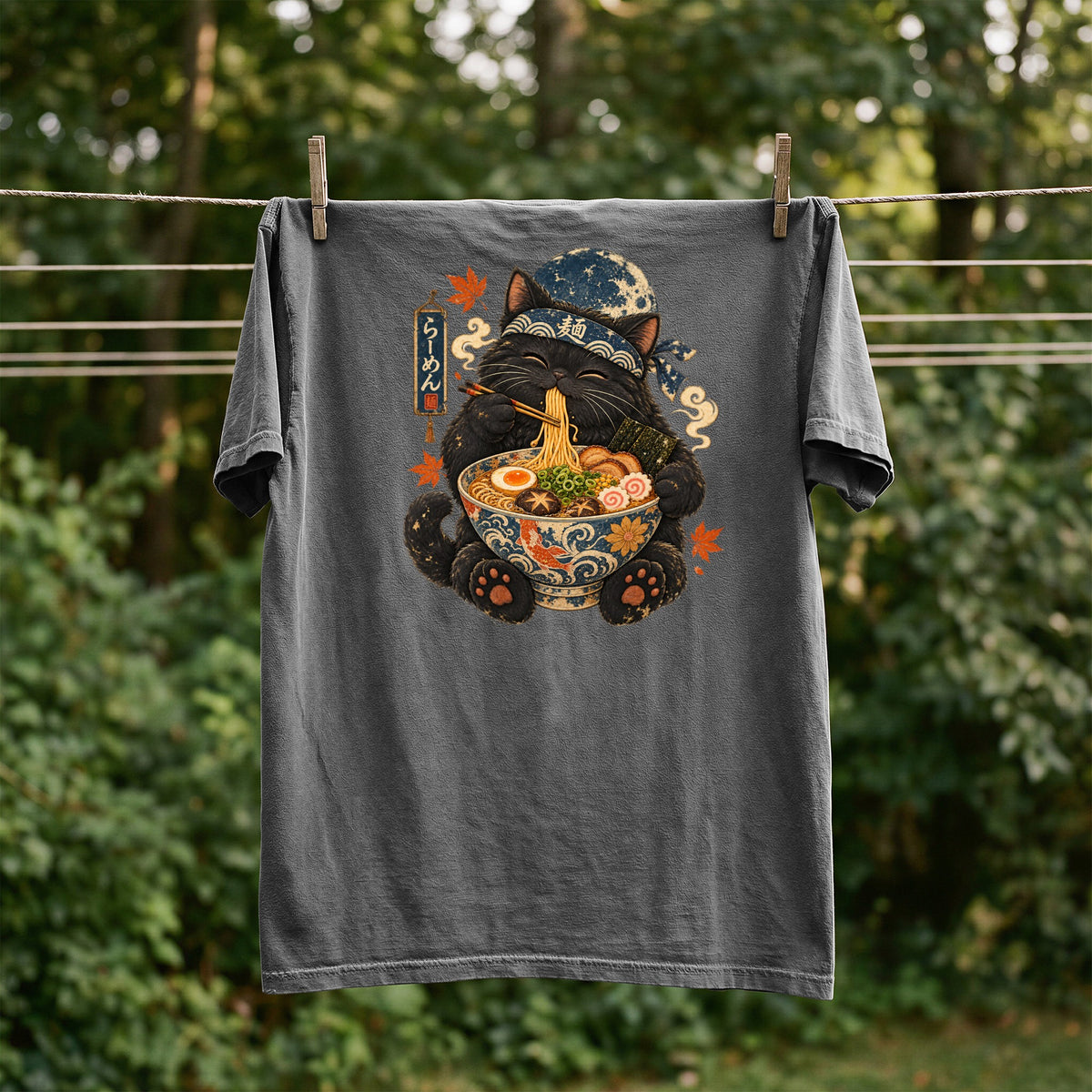 T-shirt with black cat wearing bandana eating ramen, "ramen" text.