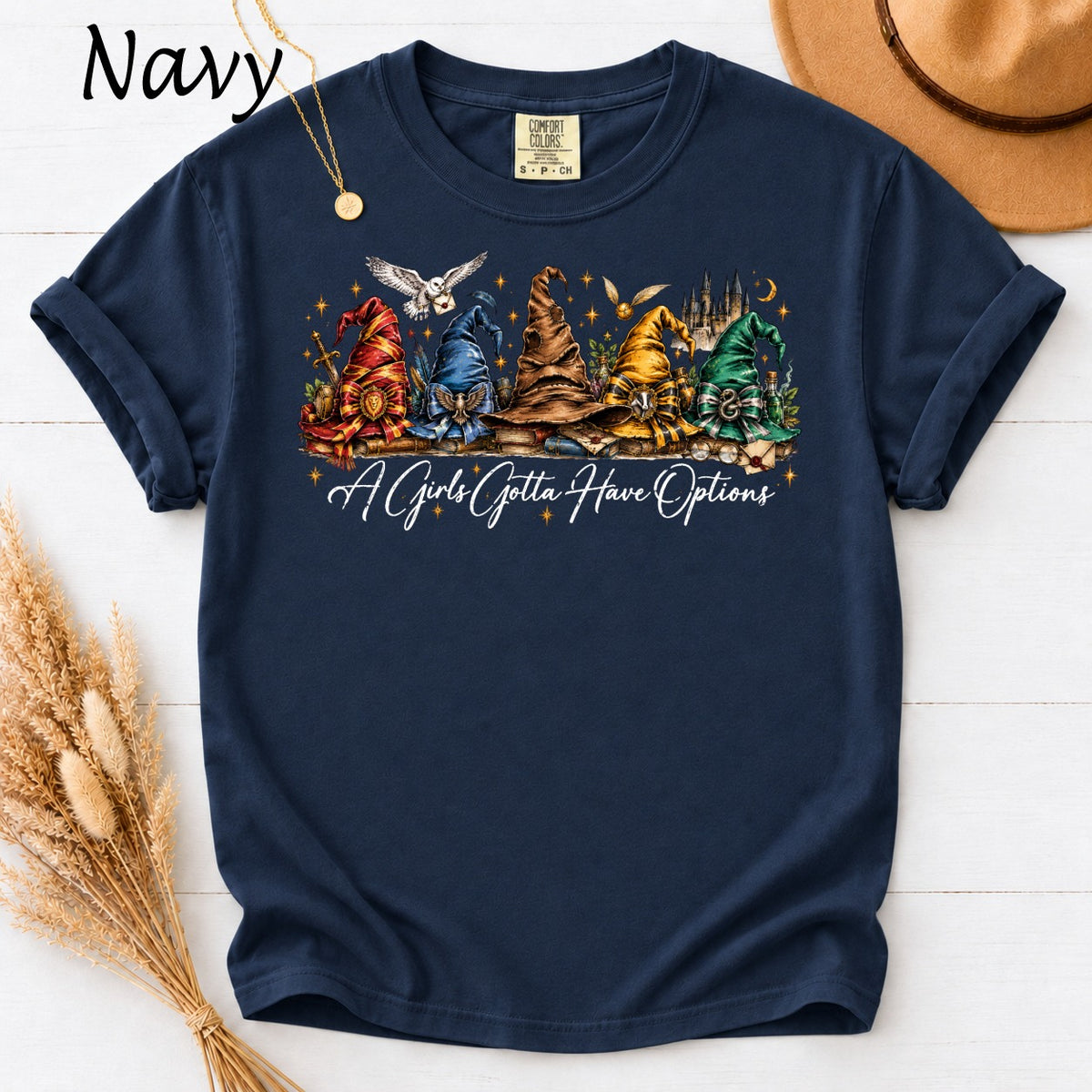 Navy t-shirt with wizard hats, Hogwarts castle, and "A Girls Gotta Have Options" text.