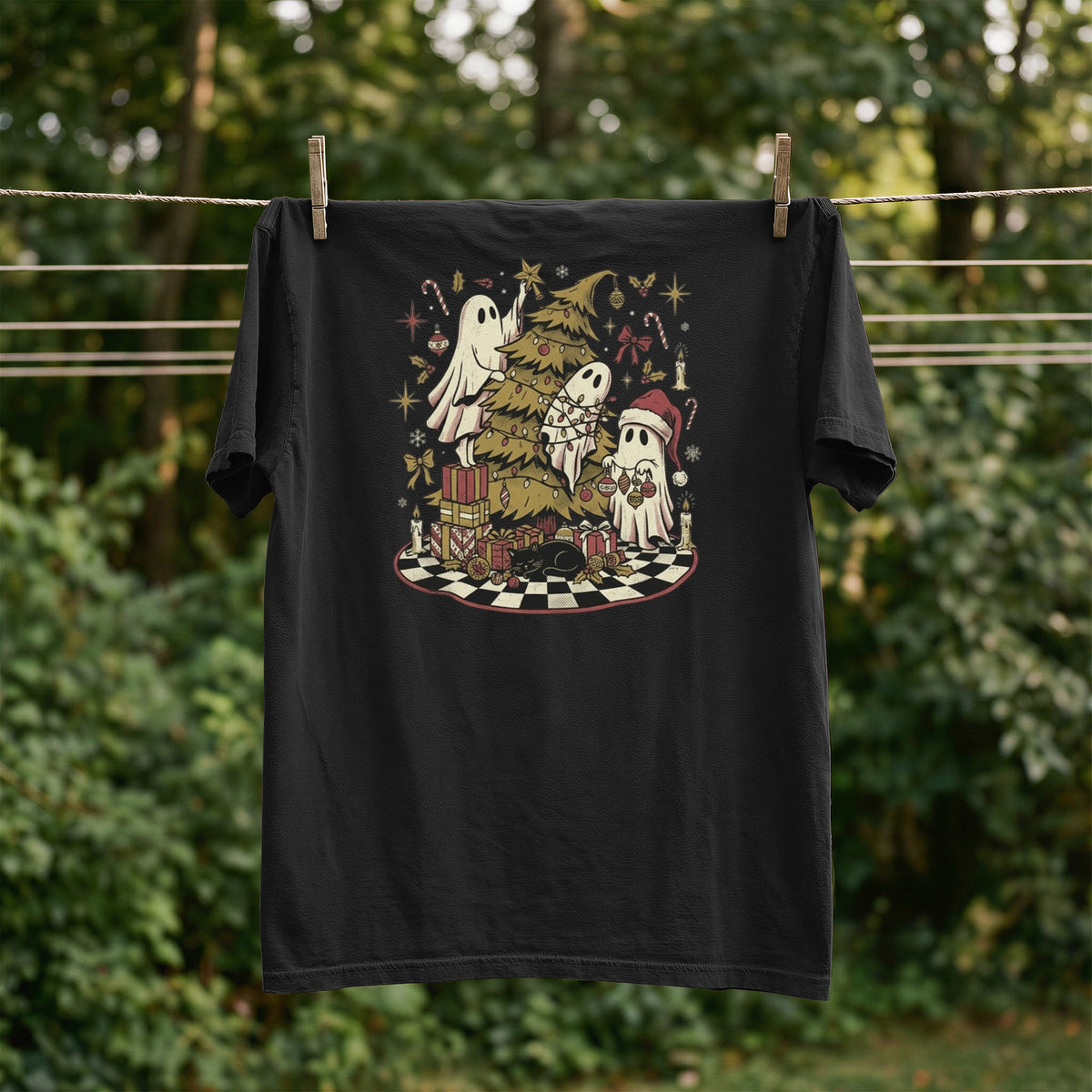 Black t-shirt with Christmas ghosts decorating a tree with presents and a black cat.