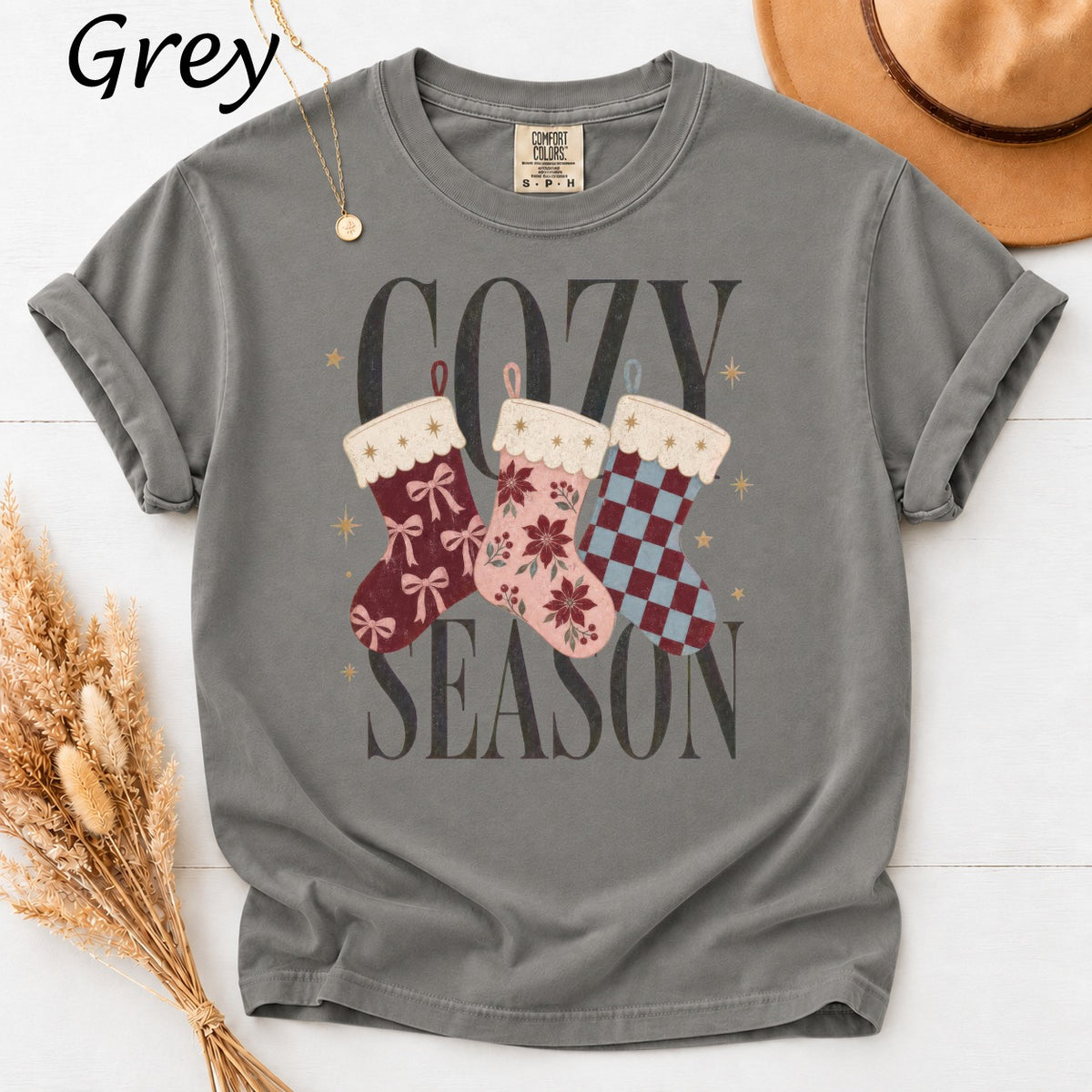 Grey t-shirt with "Cozy Season" text and three decorative Christmas stockings.