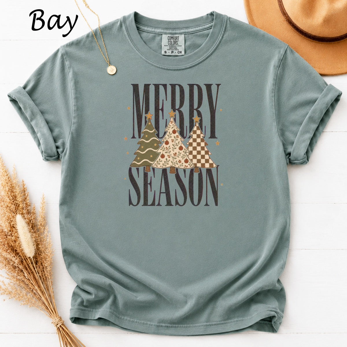 T-shirt with "Merry Season" text and three decorated Christmas trees.