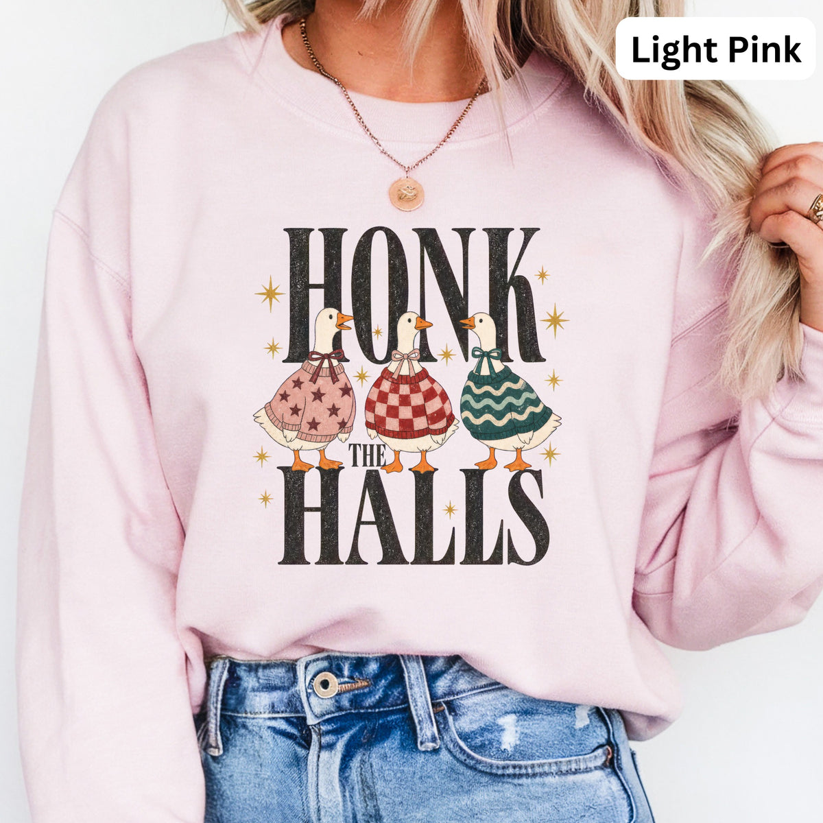 Light pink sweatshirt with "HONK THE HALLS" text and three dressed ducks.