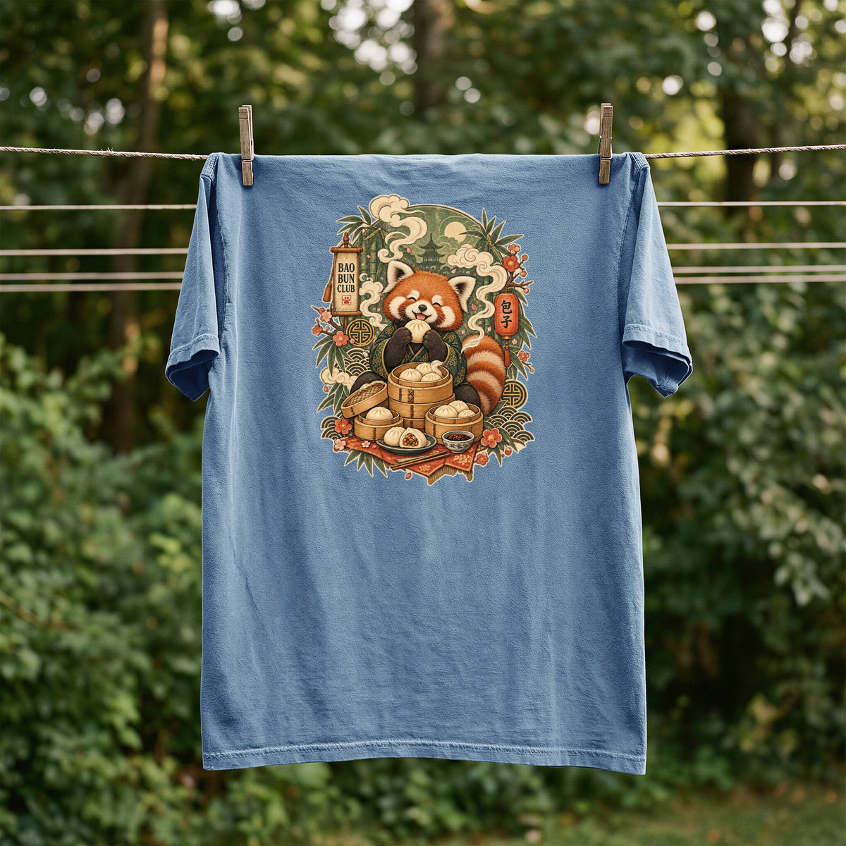 Blue t-shirt featuring a red panda eating dumplings with "Bao Bun Club" text.