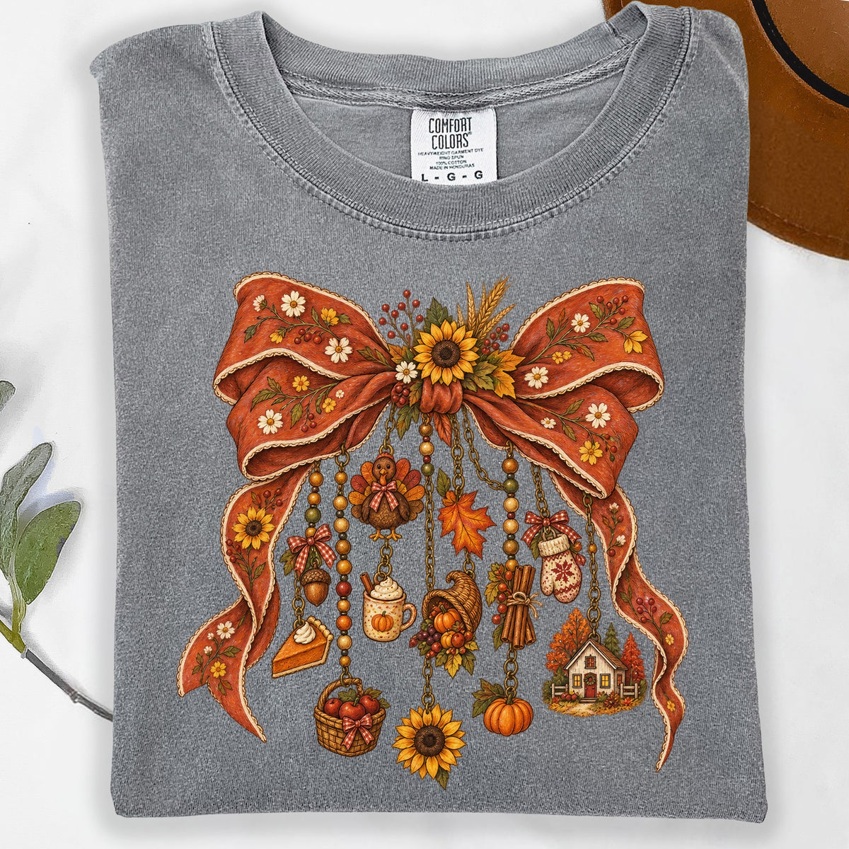 Grey Comfort Colors t-shirt with a large red bow adorned with autumn charms.