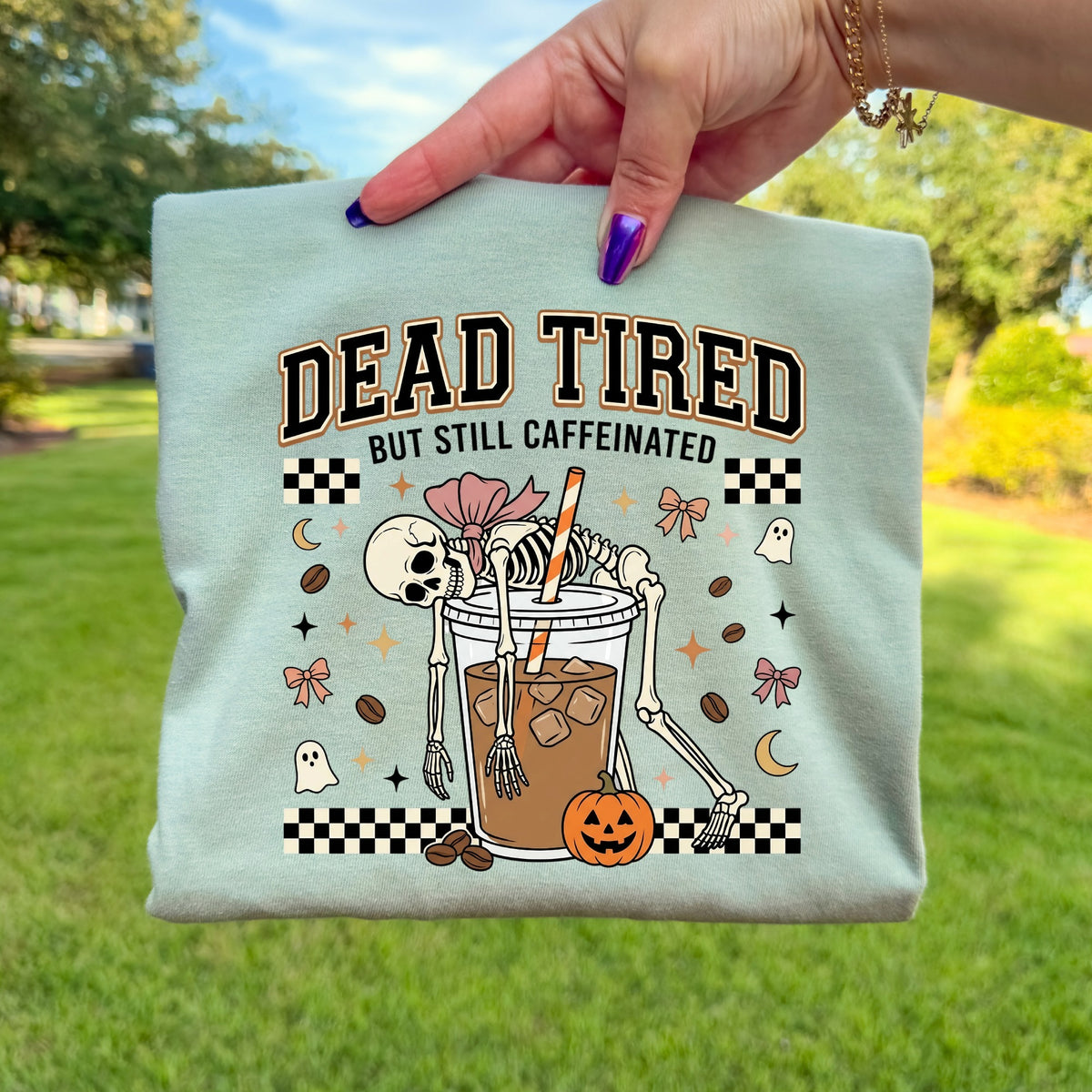 Mint t-shirt with "Dead Tired But Still Caffeinated" and skeleton with coffee.