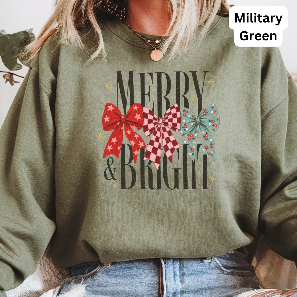 Green crewneck sweatshirt with "Merry & Bright" text and three decorative bows.