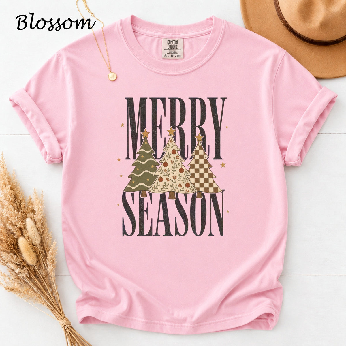 Pink t-shirt with "MERRY SEASON" text and three patterned Christmas trees.