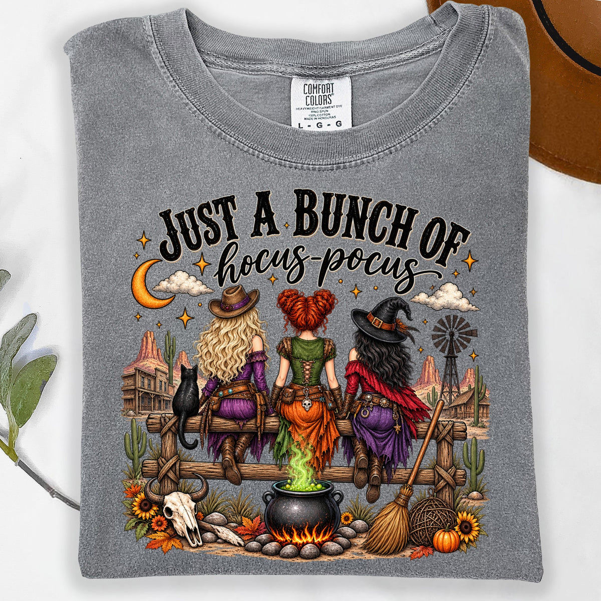 Three witches sit on a fence with "Just a Bunch of Hocus Pocus" text.