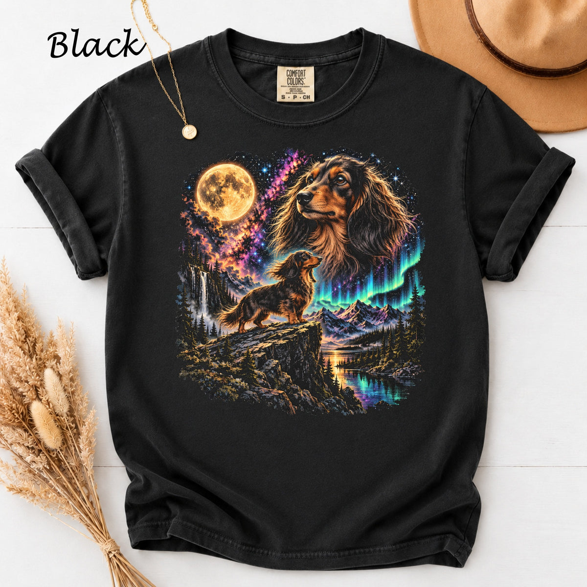 Black t-shirt with a psychedelic landscape featuring a dachshund and the aurora borealis.