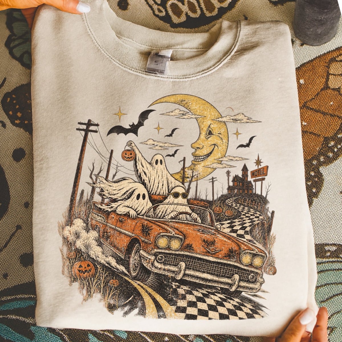 Ghosts in a convertible drive on a checkered road under a smiling moon.