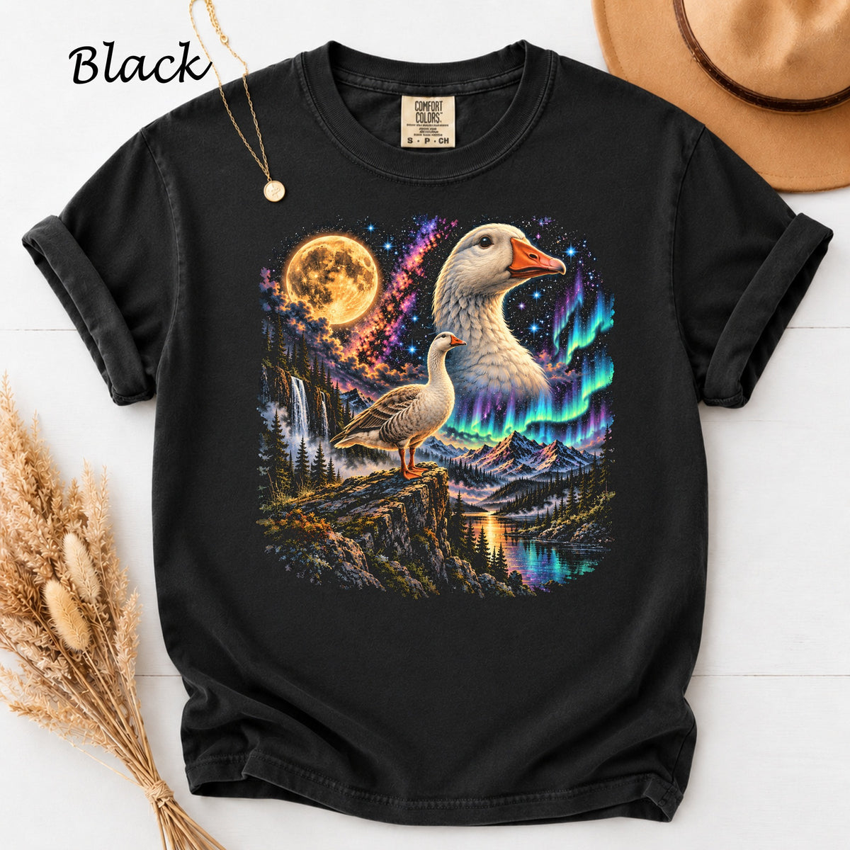 Black t-shirt with a goose on a cliff under a moonlit, aurora-filled sky.