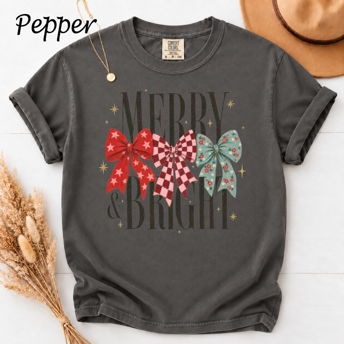 Dark gray t-shirt with "Merry & Bright" and three patterned bows.
