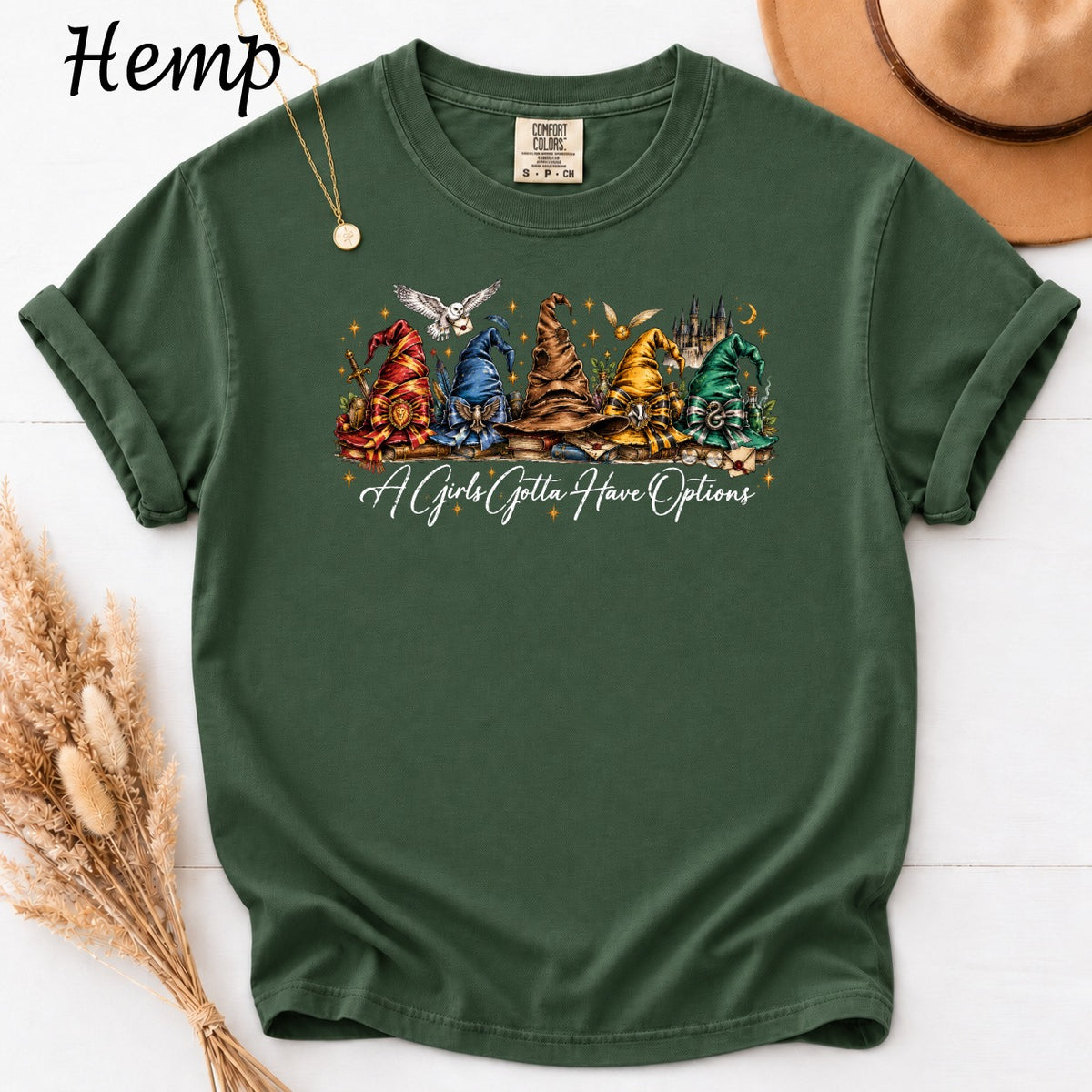 Green t-shirt with wizard hats and "A Girl's Gotta Have Options" text.
