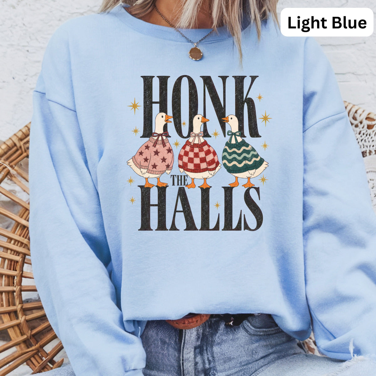 Light blue sweatshirt with "HONK THE HALLS" text and three geese.