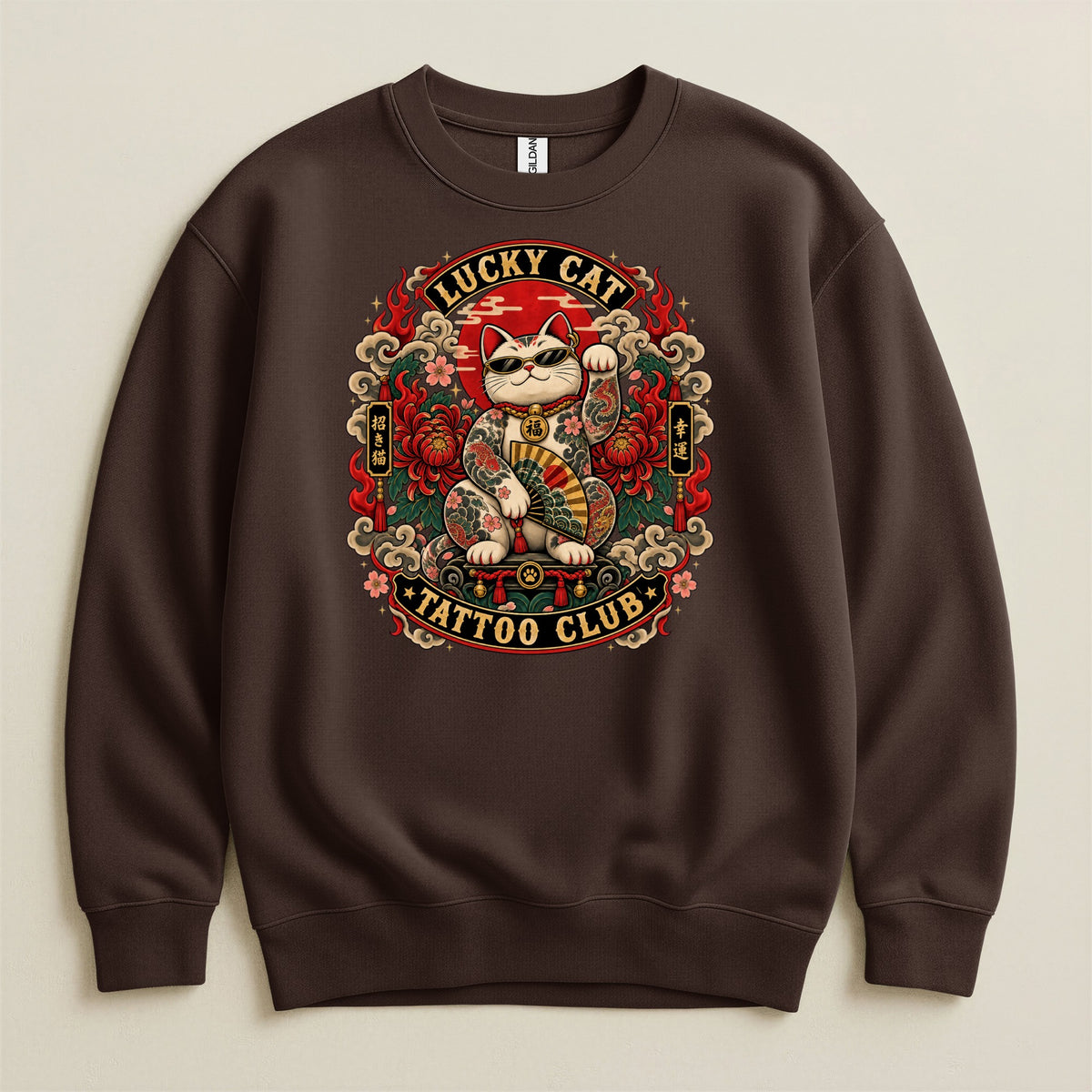Brown sweatshirt featuring a lucky cat graphic with tattoos and sunglasses, and text "Lucky Cat Tattoo Club."