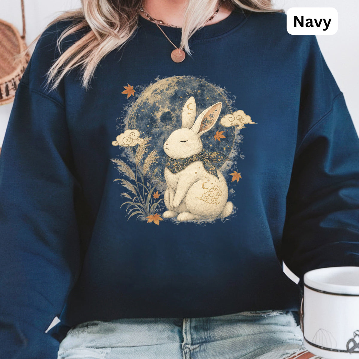 Navy sweatshirt with a graphic of a white rabbit under the moon and clouds.