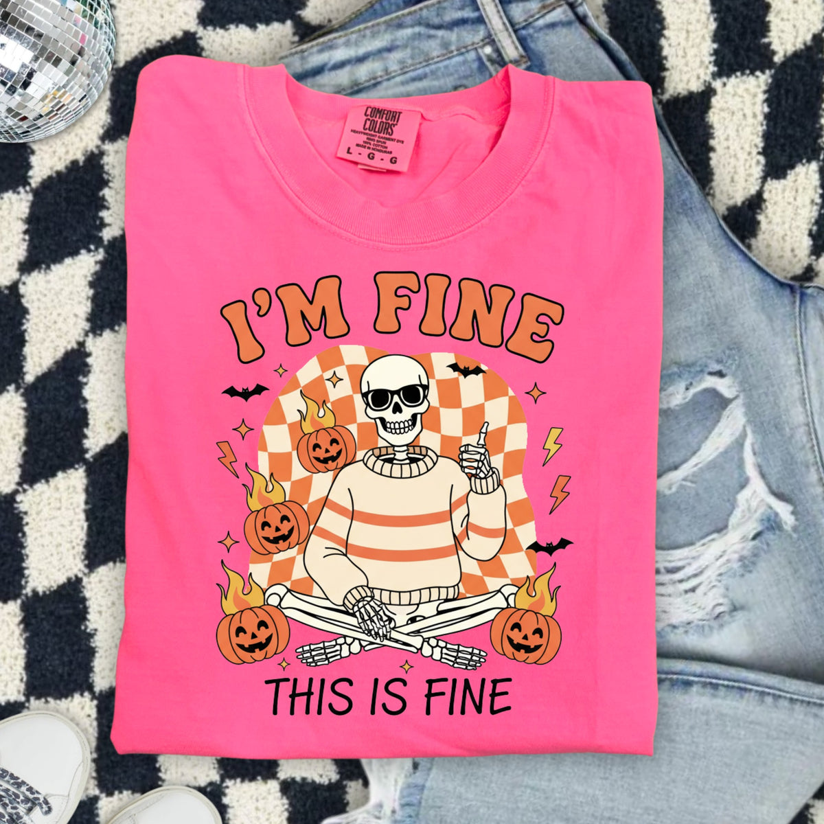 Pink t-shirt with skeleton graphic saying "I'M FINE THIS IS FINE".