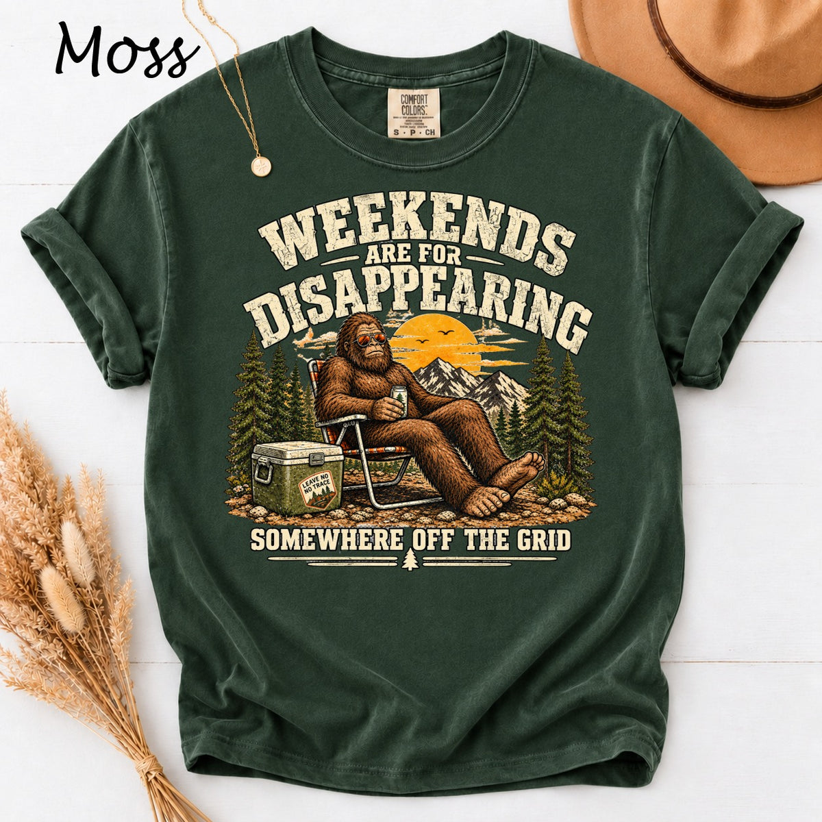 Bigfoot sits in a chair with "Weekends are for Disappearing Somewhere Off the Grid" text.