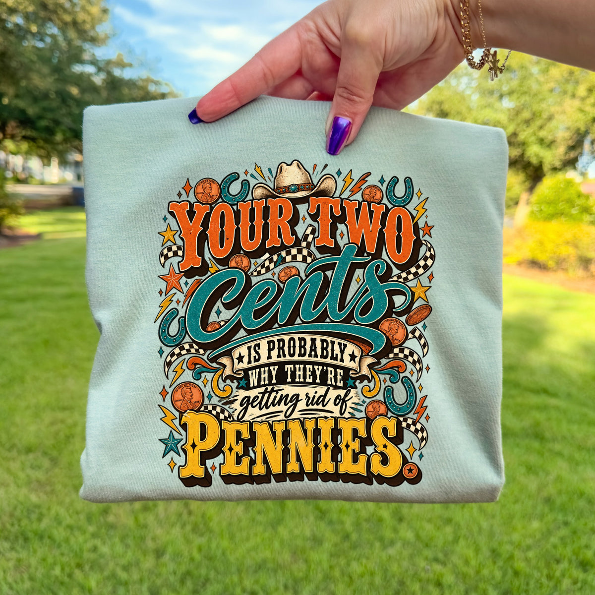 Light blue t-shirt with "Your Two Cents Is Probably Why They're Getting Rid Of Pennies" text and graphics.