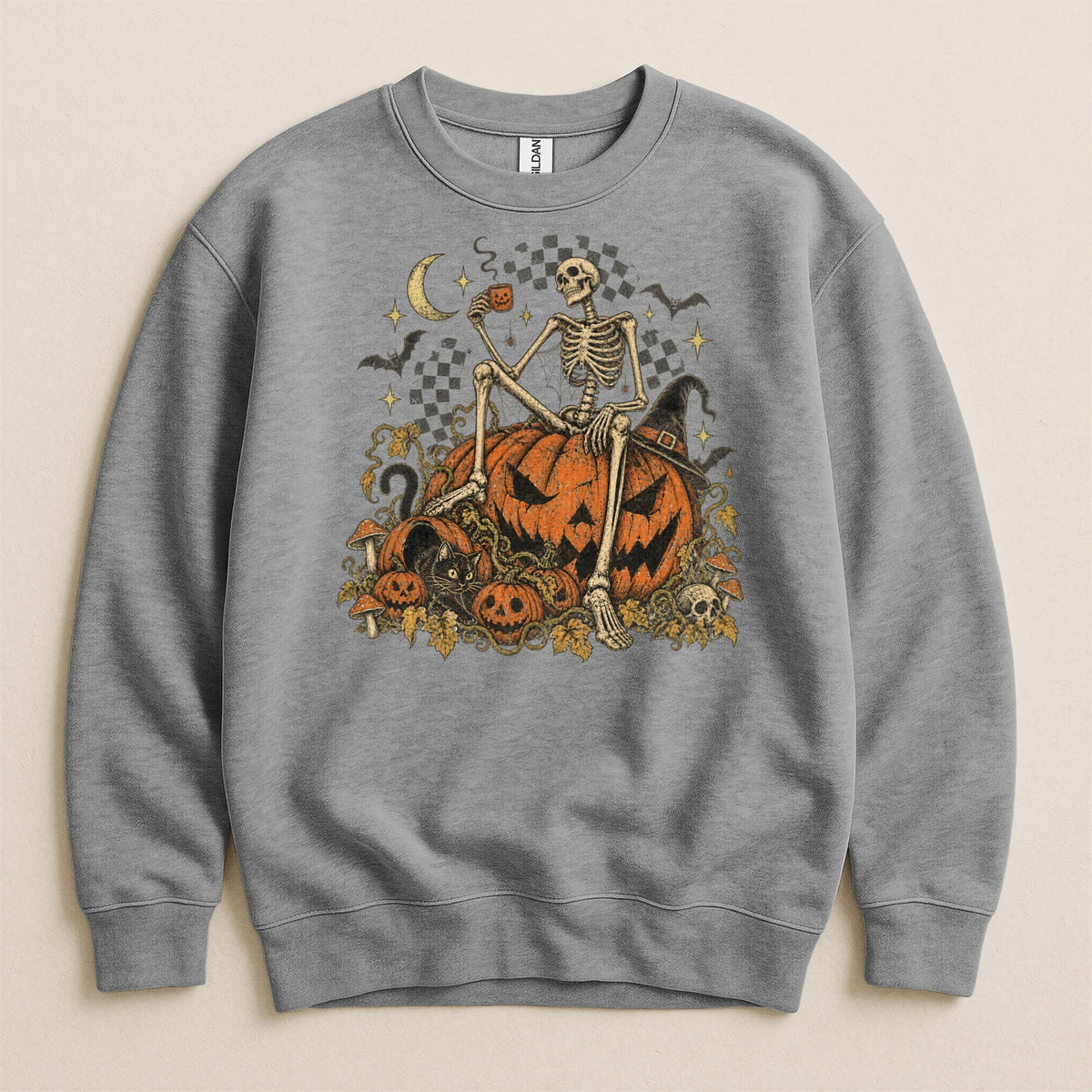 Skeleton sitting on pumpkins holding a coffee cup with Halloween-themed graphics.
