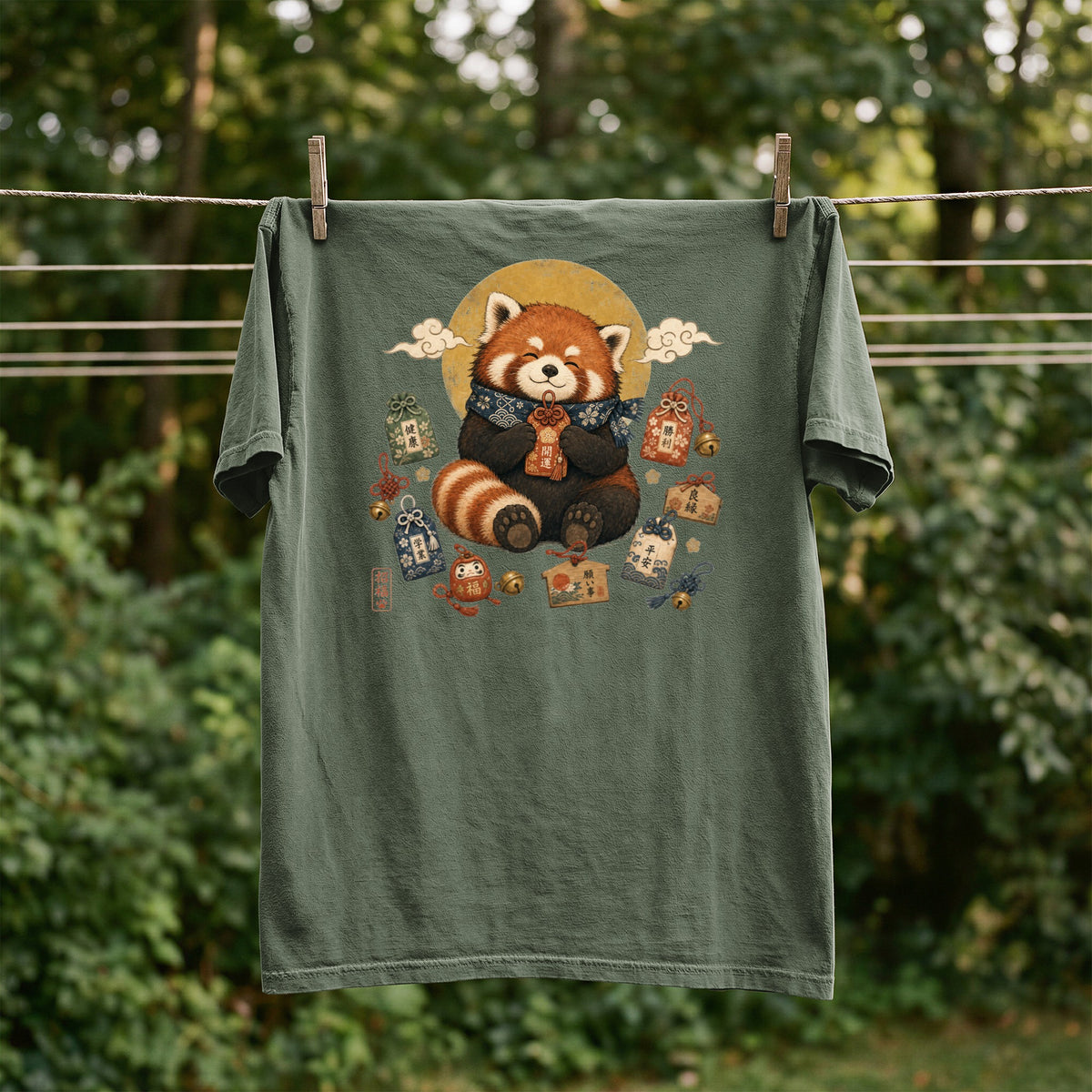 Green t-shirt with red panda illustration surrounded by Japanese good luck charms.