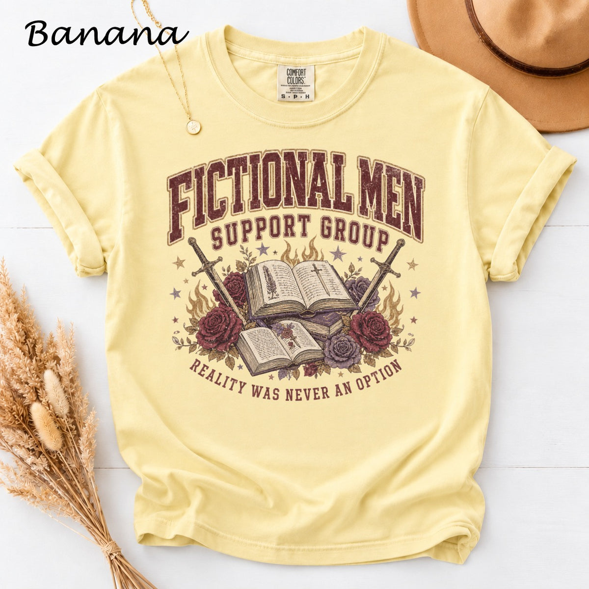 Yellow t-shirt with "Fictional Men Support Group" graphic and sword.