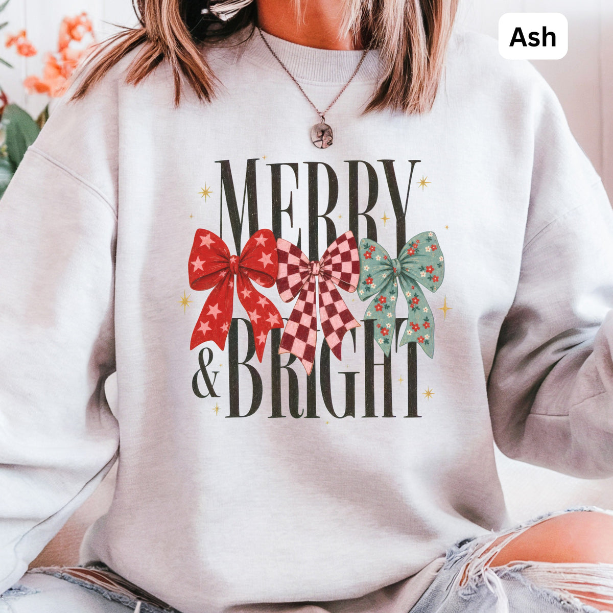Light grey sweatshirt with "Merry & Bright" text and three festive bows.