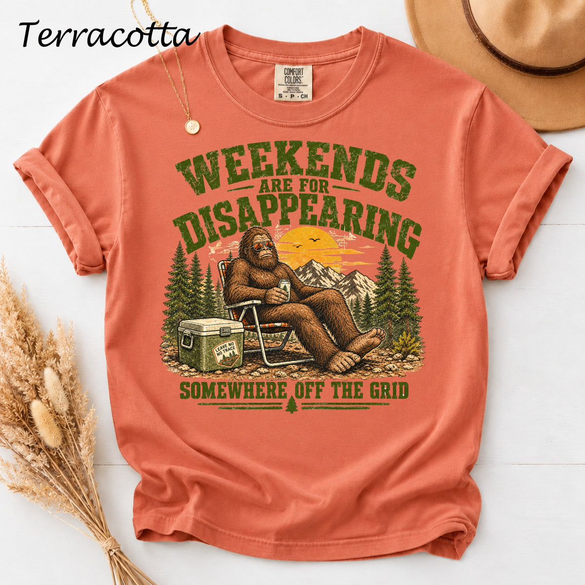 Terracotta t-shirt with Bigfoot sitting in a chair with "Weekends are for disappearing" text.