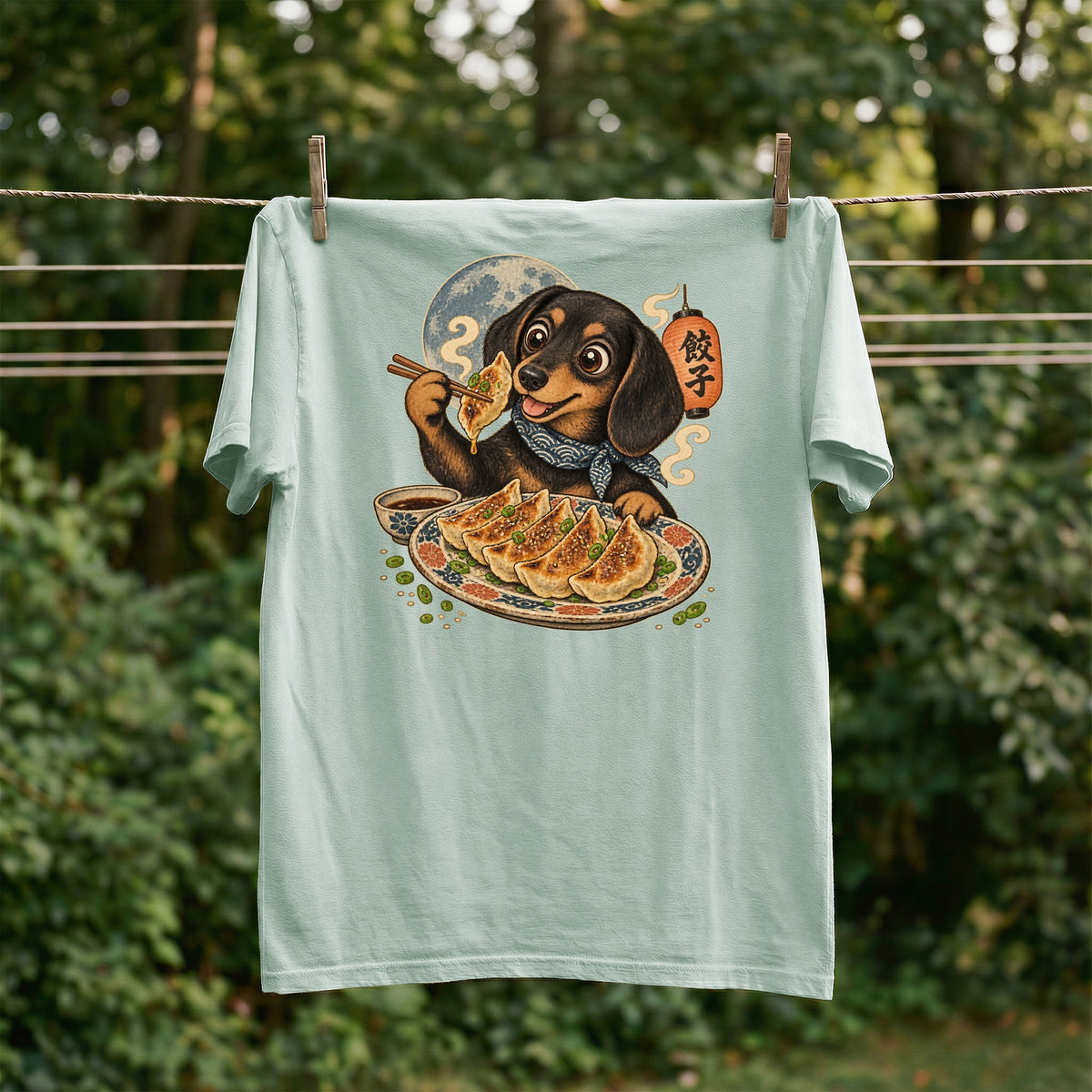 Light blue t-shirt with dachshund eating dumplings graphic and Japanese text.