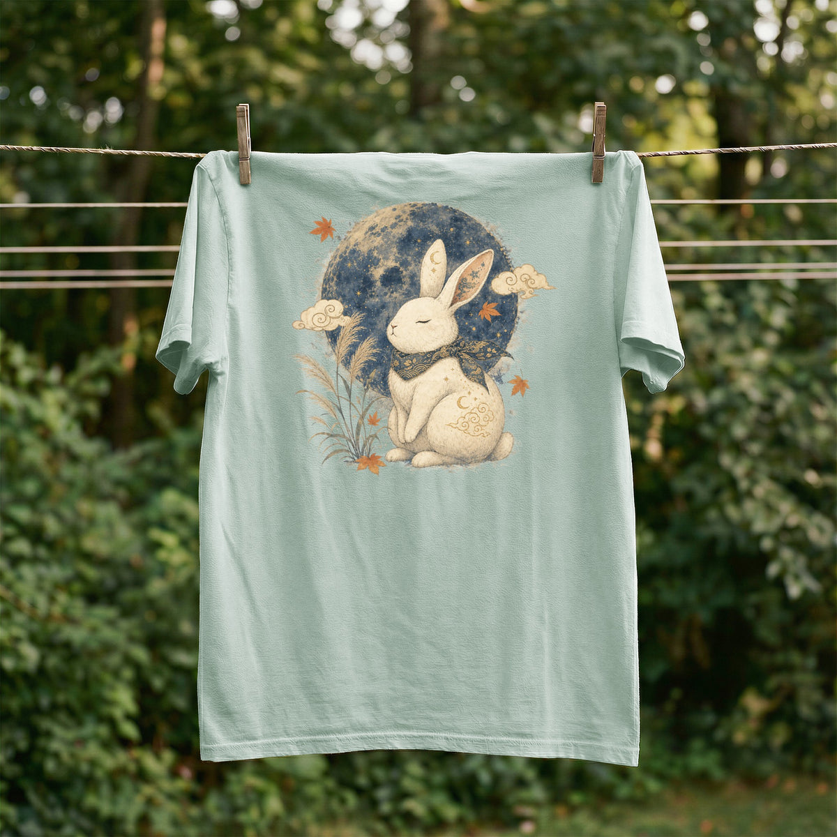 Light teal t-shirt with a white rabbit and full moon design.