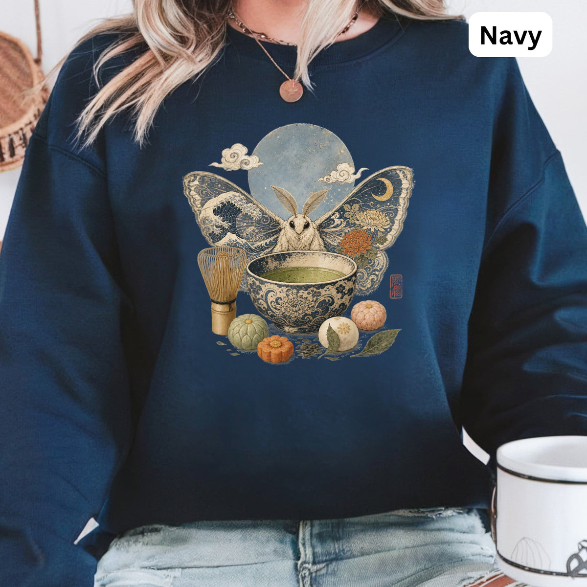 Moth with large patterned wings, moon, clouds, and matcha tea set.