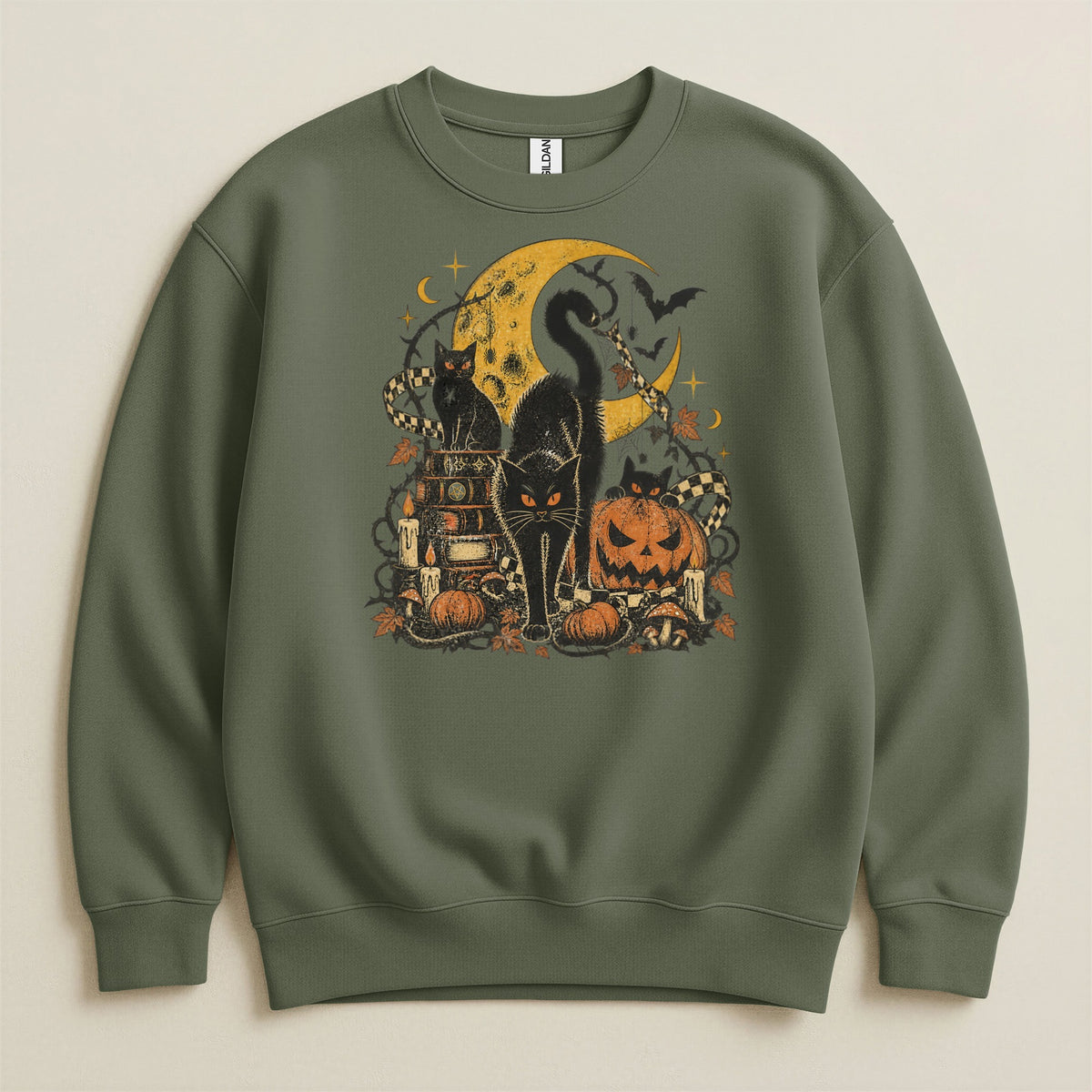Green sweatshirt with Halloween graphic featuring black cats, moon, pumpkins, and books.