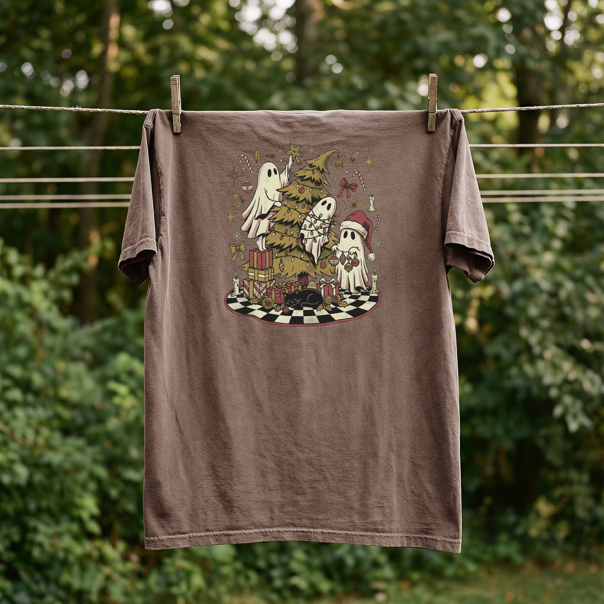 Brown t-shirt with ghosts decorating a Christmas tree, surrounded by presents and a black cat.