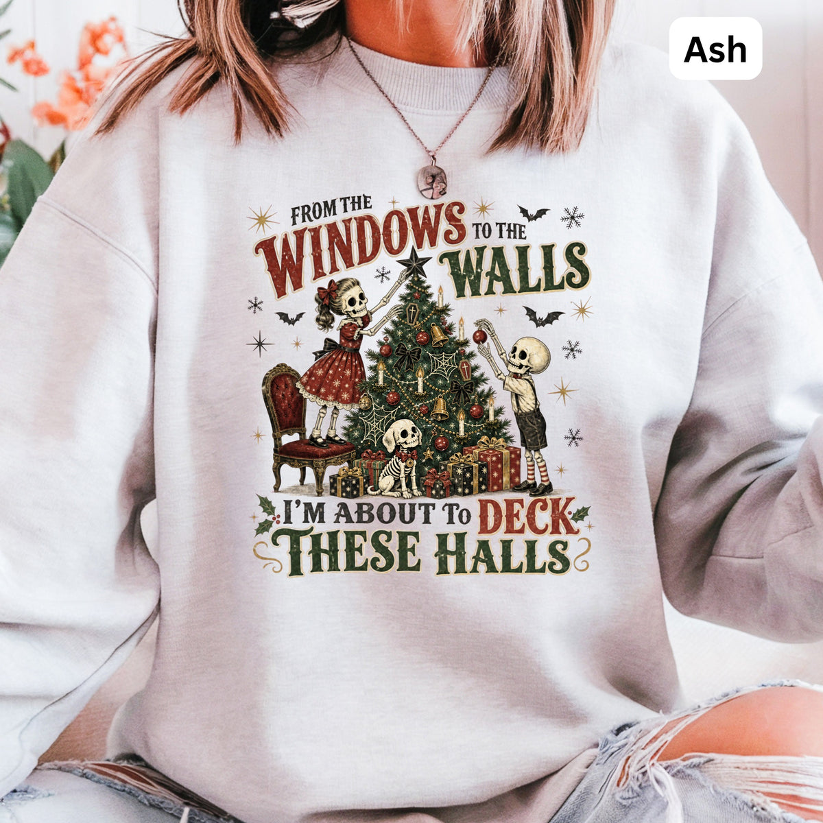 Skeleton figures decorate a Christmas tree with text "I'm about to deck these halls".